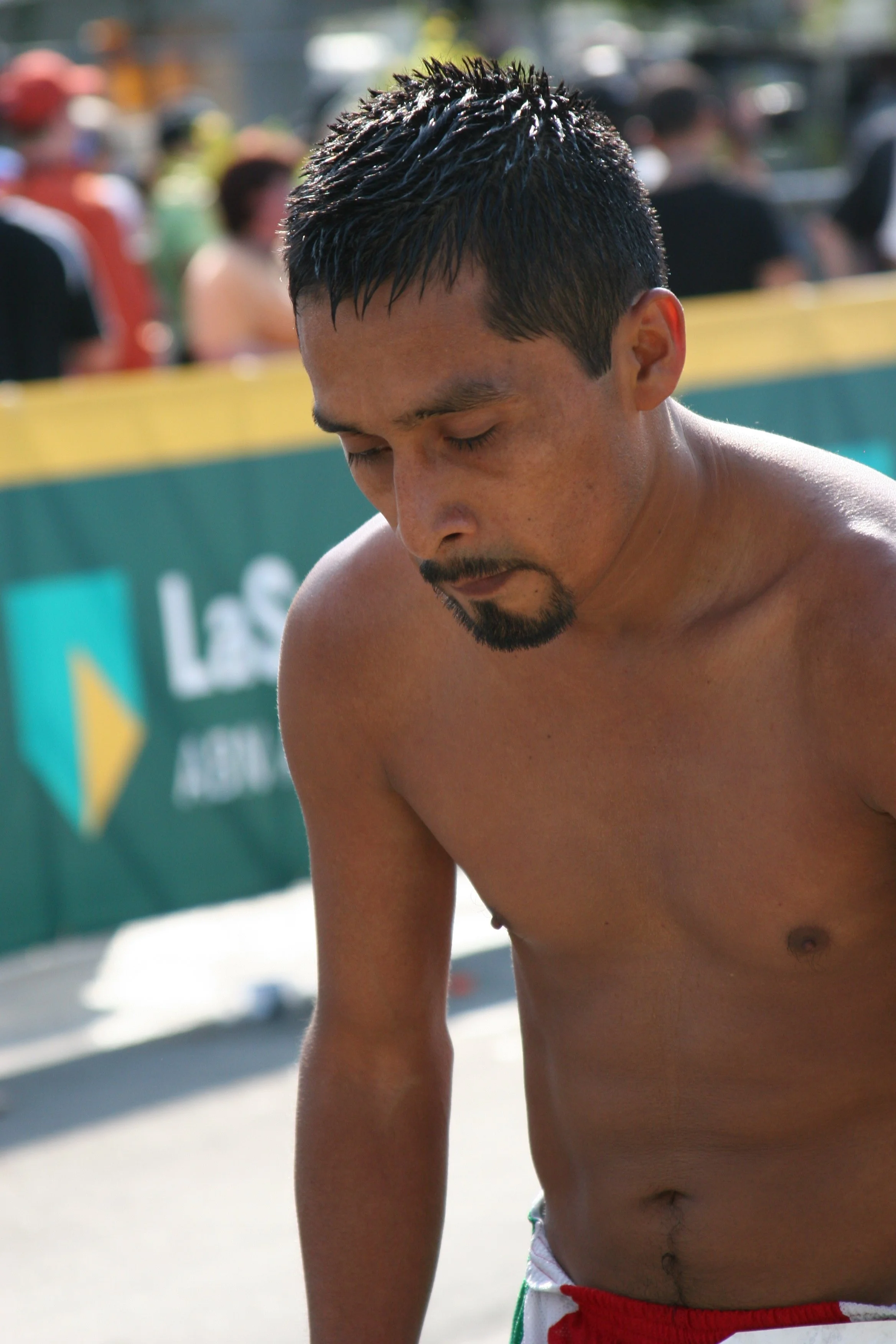 Close-up of a shirtless man with wet hair and closed eyes.