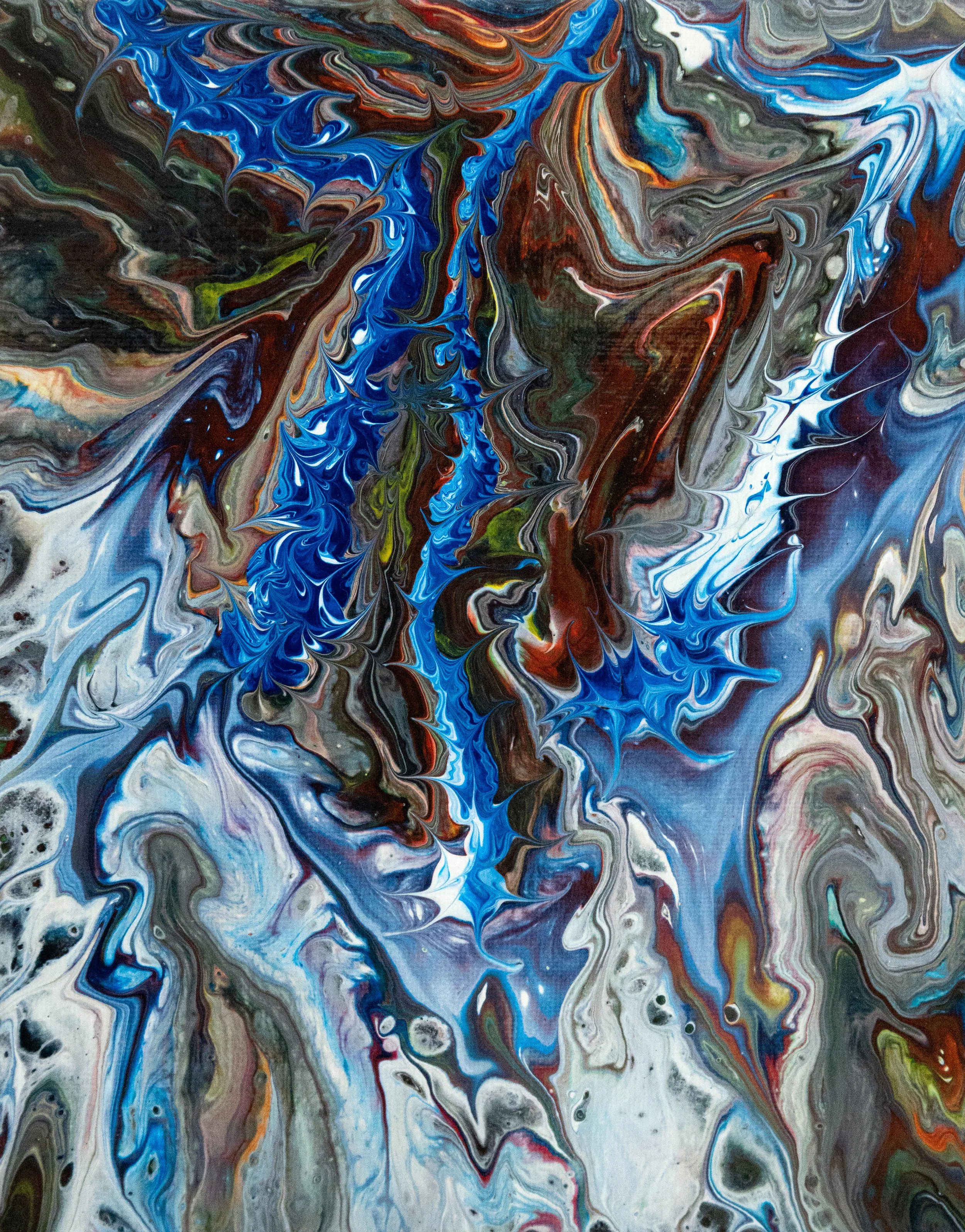 A vibrant abstract painting featuring swirling colors including blue, red, black, white, and green.