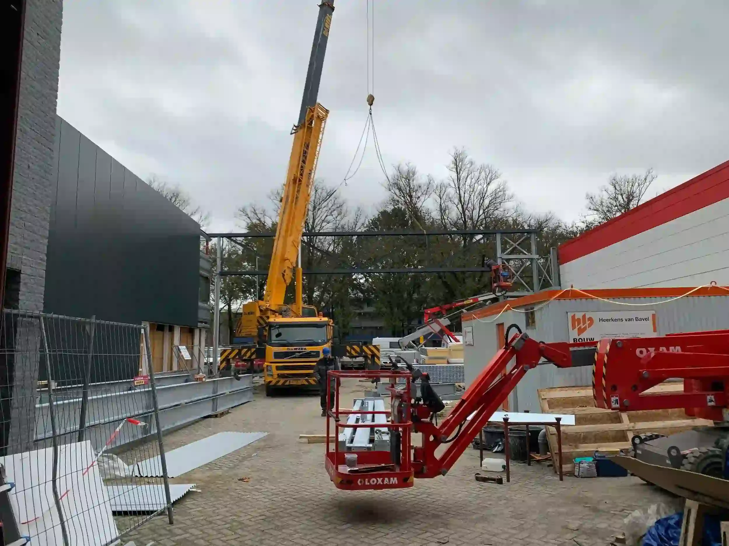 Construction site with cranes and lift equipment during self-storage facility renovation