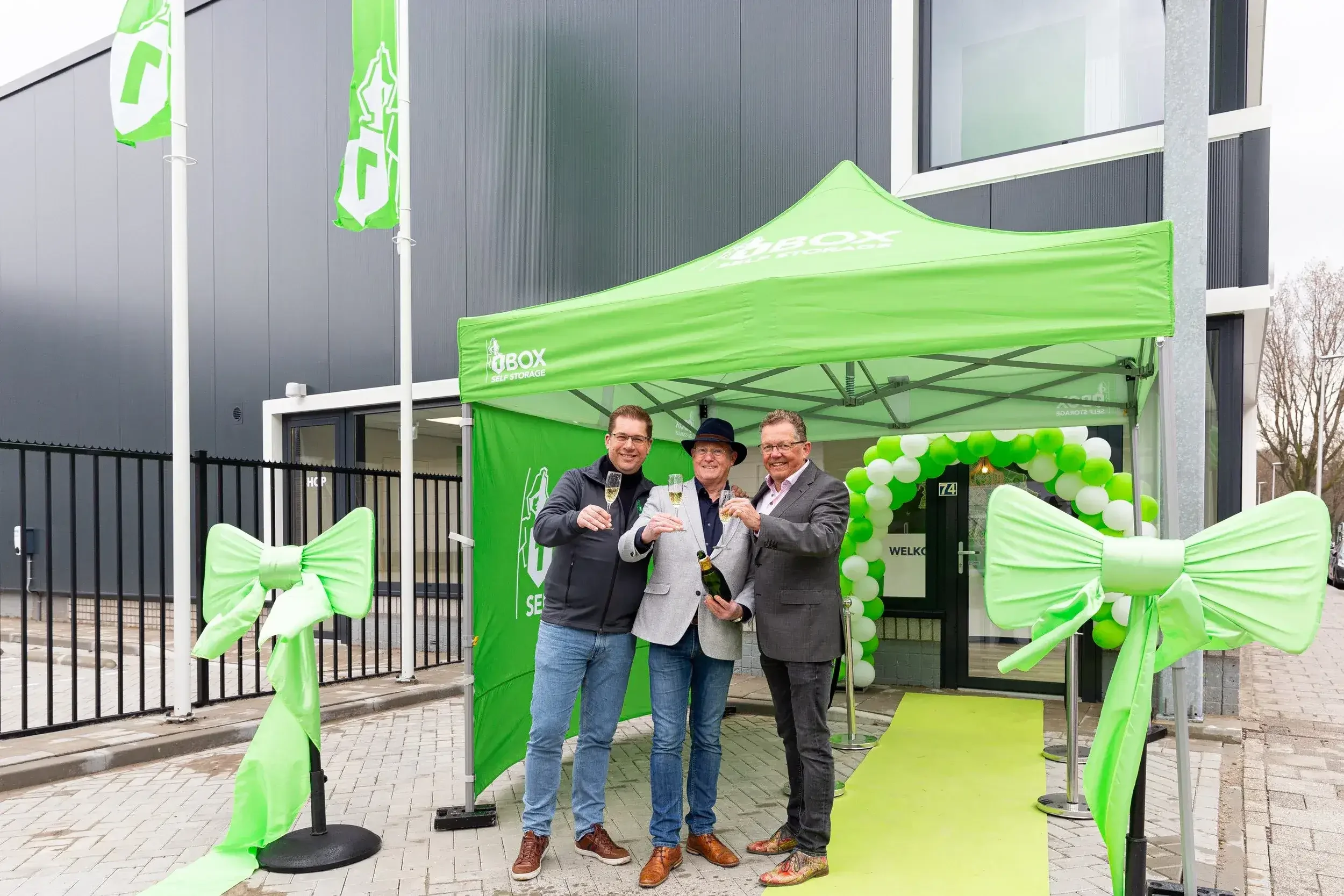 Ribbon-cutting ceremony outside newly opened self-storage building