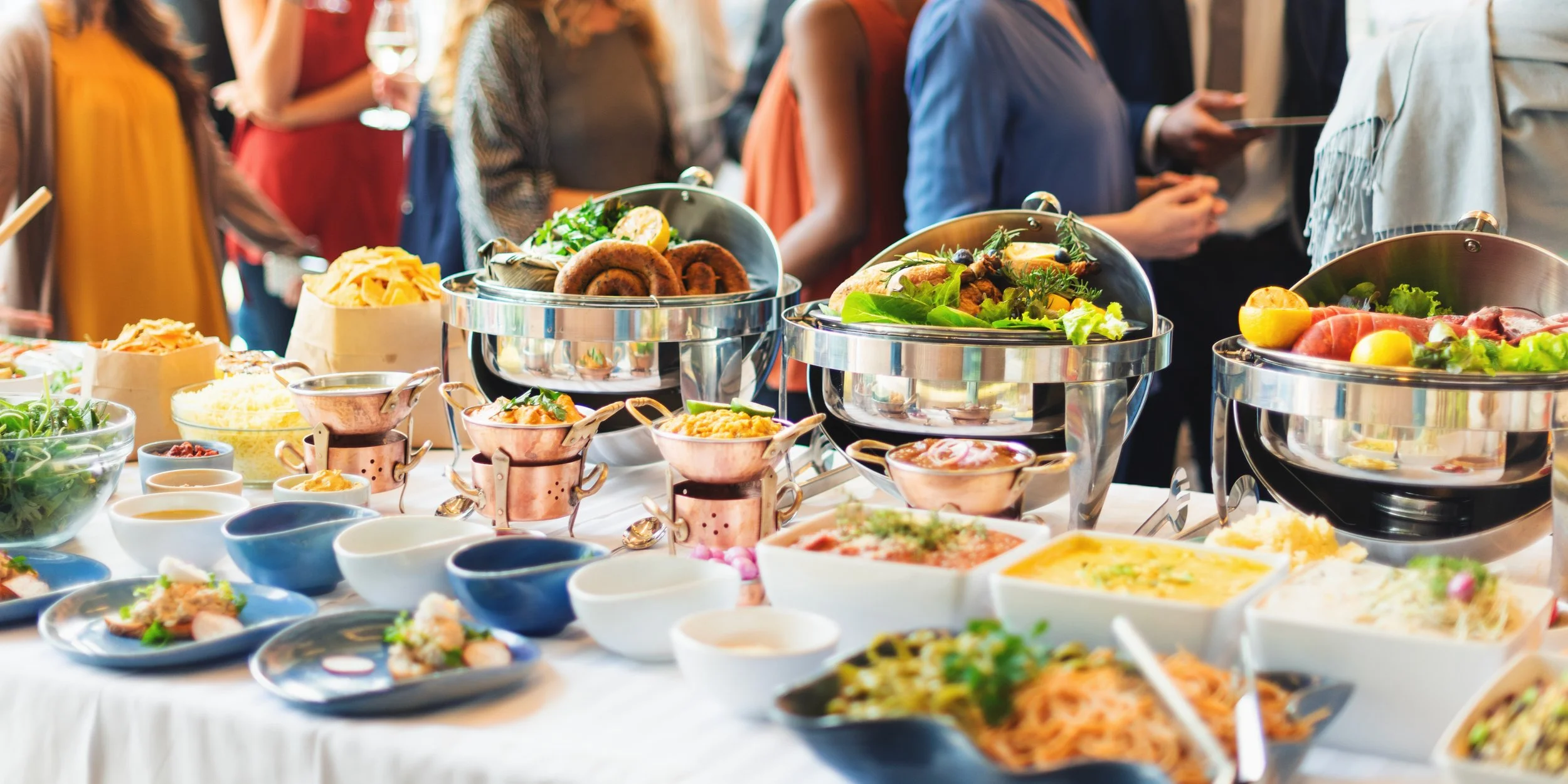 buffet_table_with_variety_dishes_social_event_happy_diverse_people.jpg