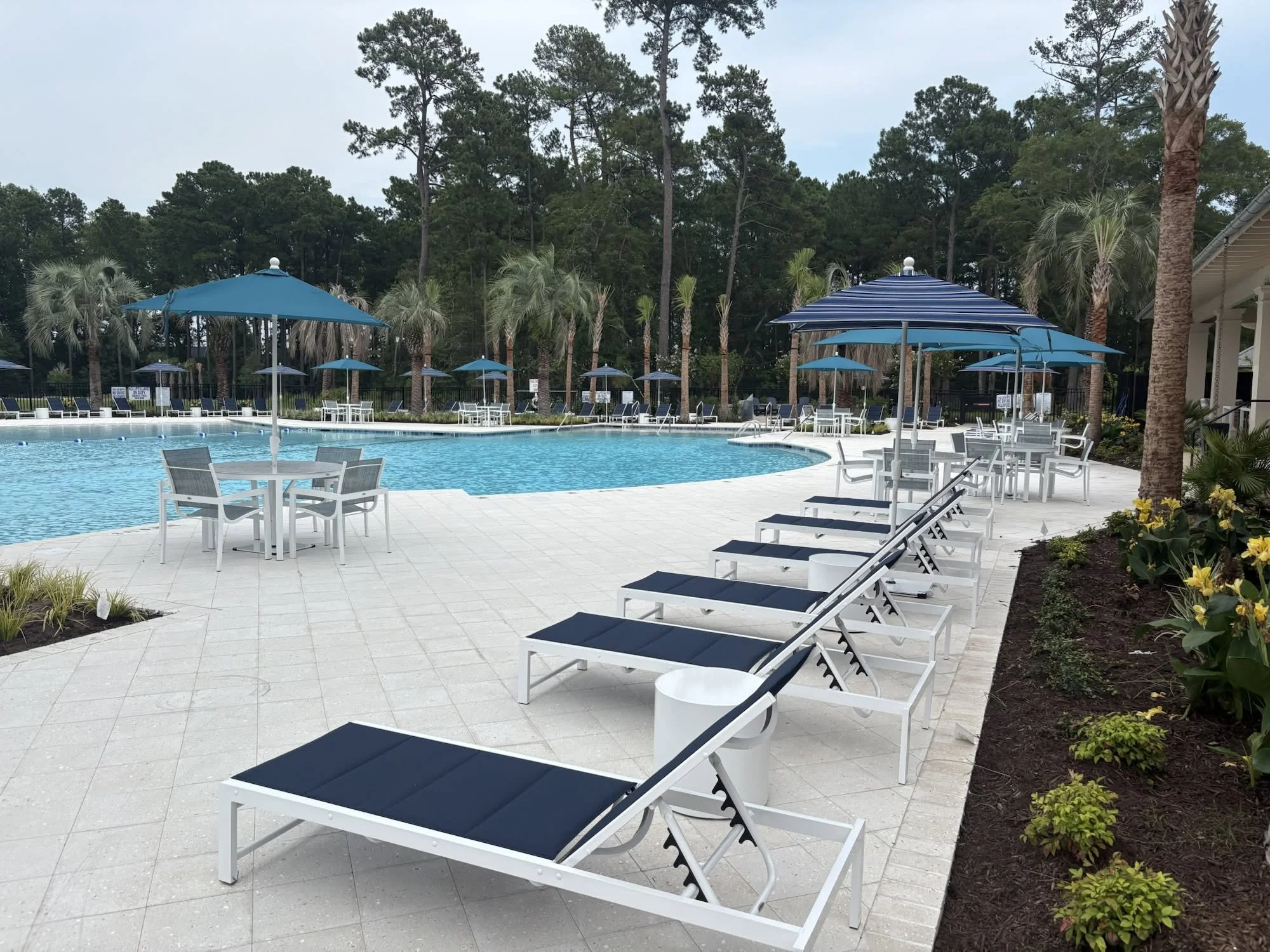 Lounge seating by the pool with integrated landscaping next to the resort-style pool