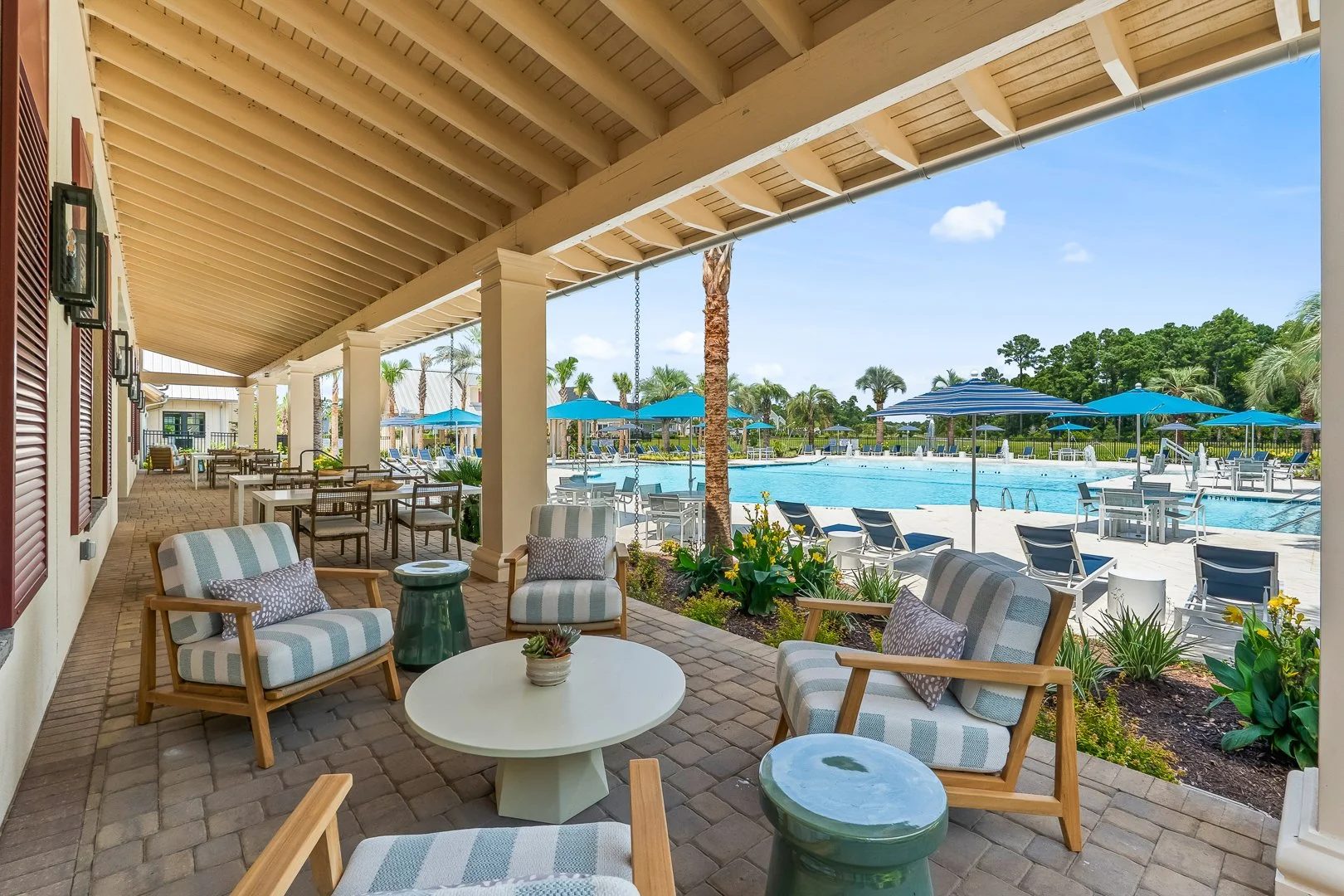 Porch seating area overlooking the social pool at Grande Dunes North Amenity Center