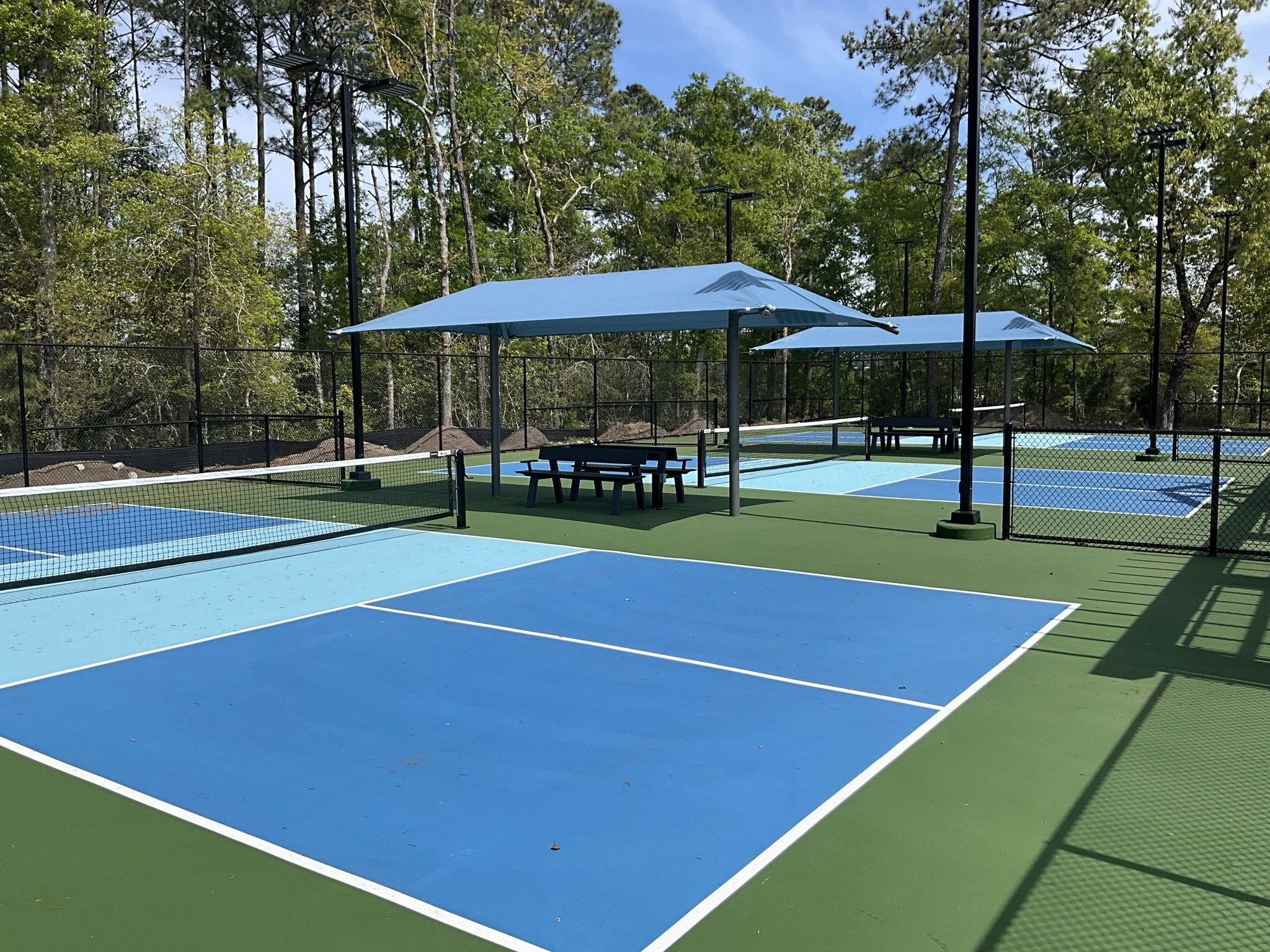 Pickleball courts with shaded pavilions
