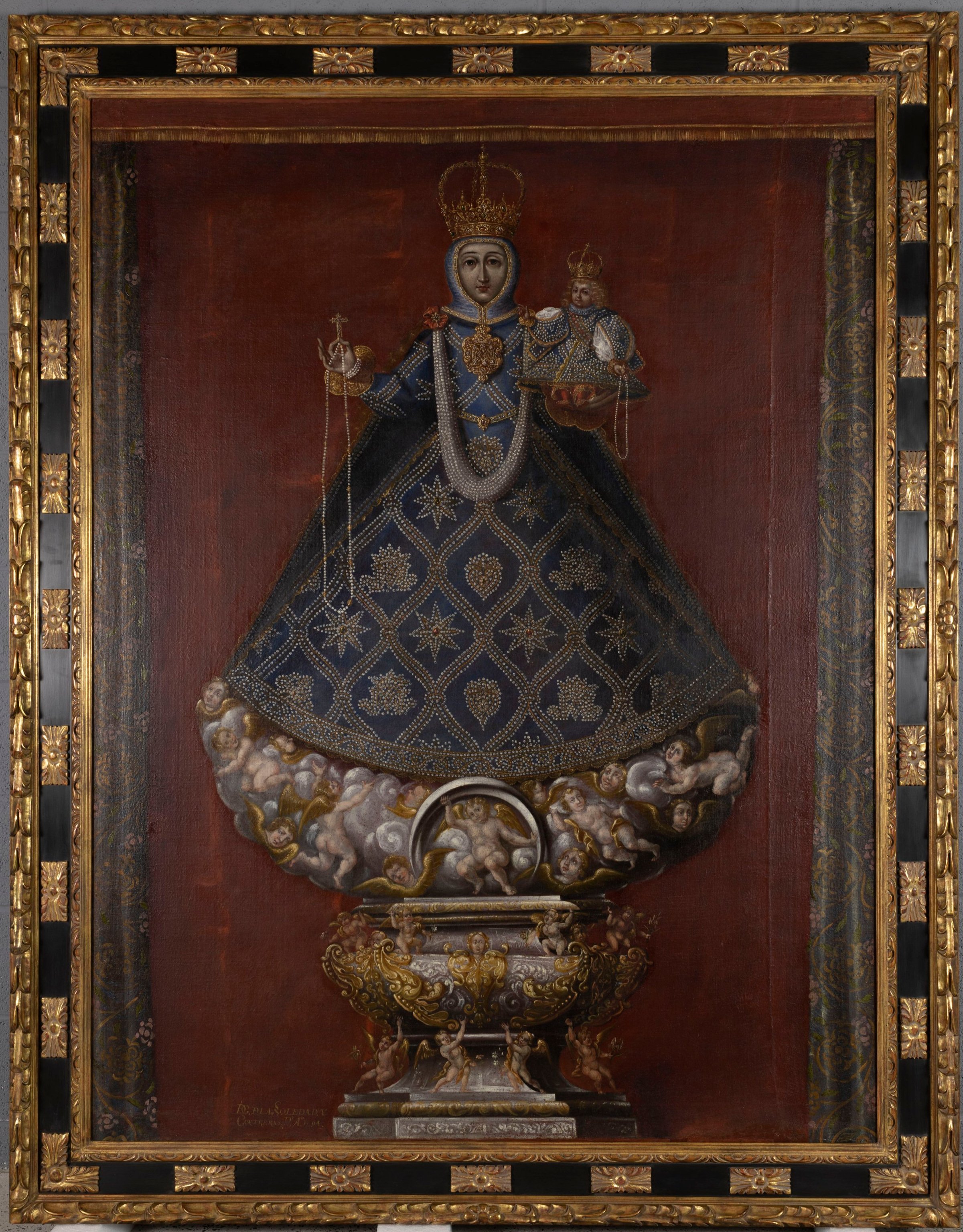 After treatment photograph of the painting of the Madonna and Jesus with all damage fixed and in its new highly decorative gold and black frame