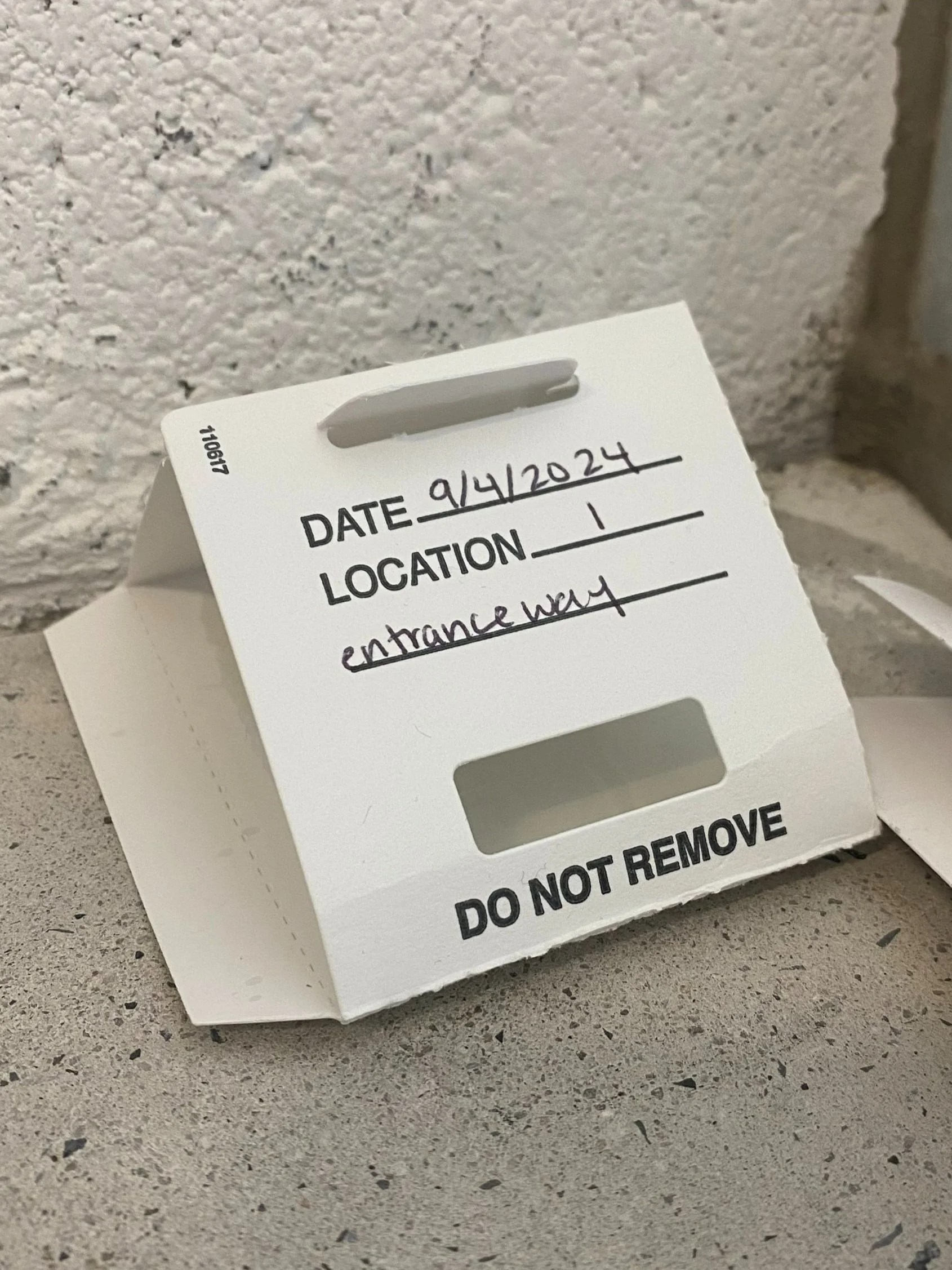a sticky trap - a thin, white cardstock folded to form a little, triangular tent with a space for the date and location to be written on it