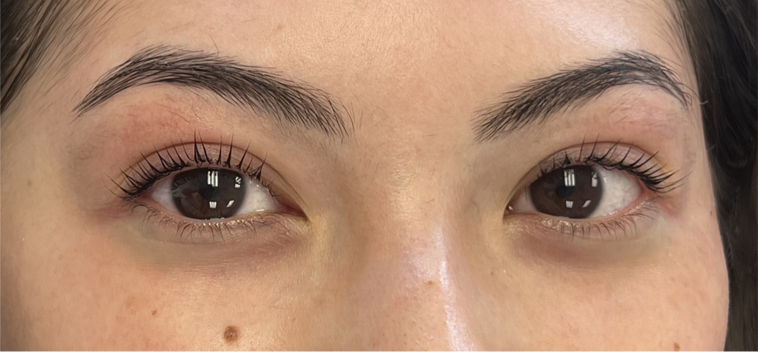 Close-up of a woman's eyes with a lash lift and tint and well-groomed eyebrows.