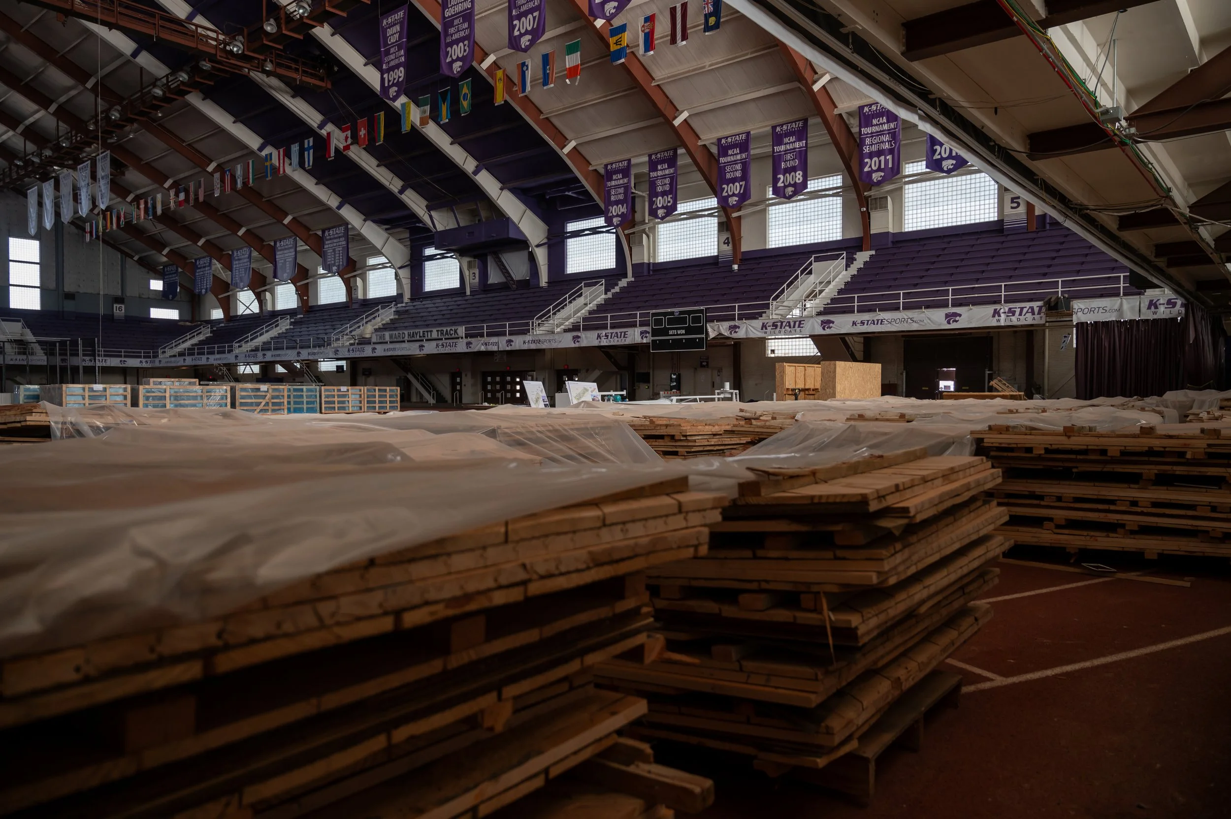 Pallets of the original basketball court from Ahearn Field House sit cut and stacked on pallets inside the facility at Kansas State University on March 25, 2026. 