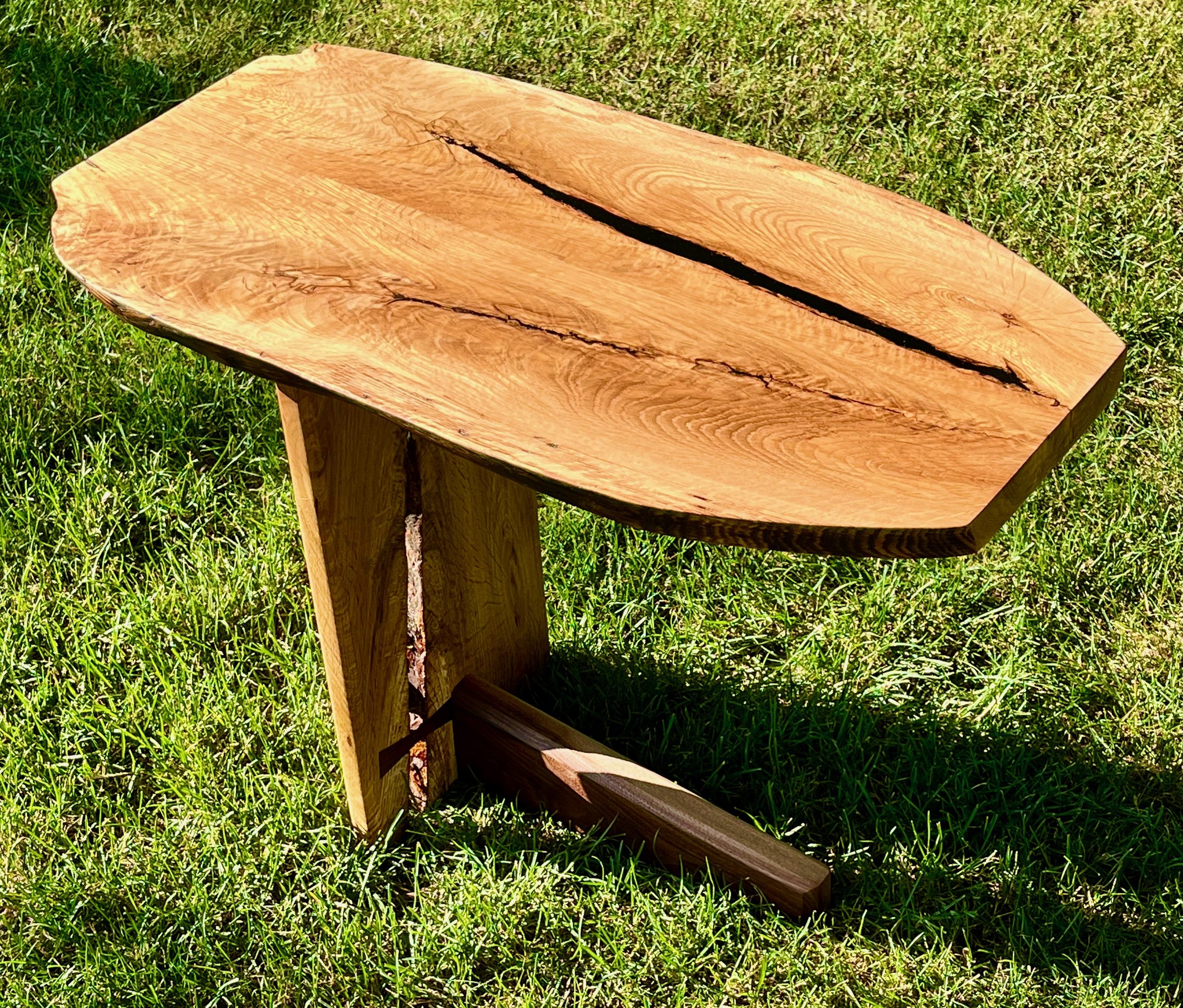Picture 3 of a white oak and walnut side table. This feature a top that canitlevers off of a single leg and foot.