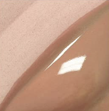 Close-up of a shiny, curved beige object, possibly a nail or a piece of jewelry.
