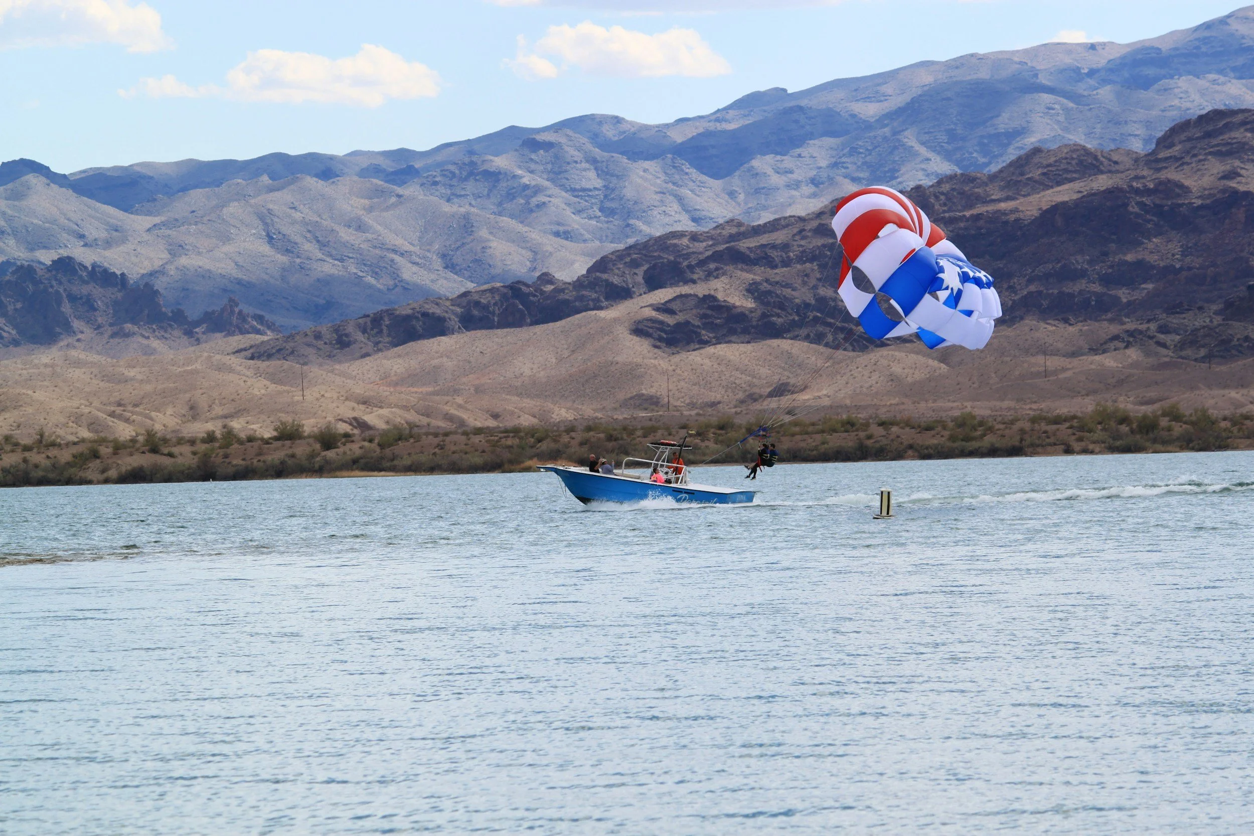 boat on water with a para sail and person in air on Walker Lake Nevada