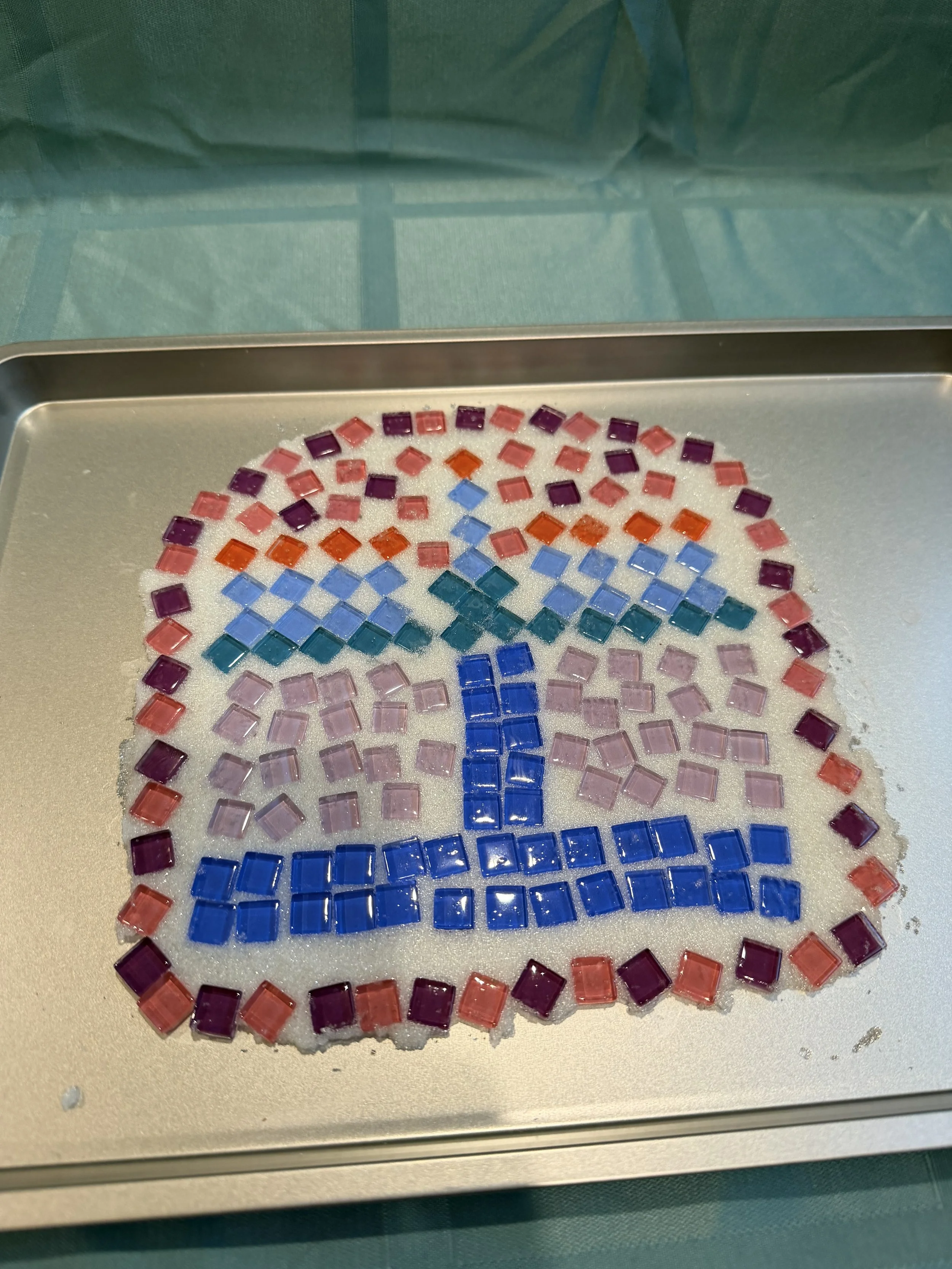 Keep homes safe and beautiful with this candle drip tray made from a baking sheet, tiles, and grout.