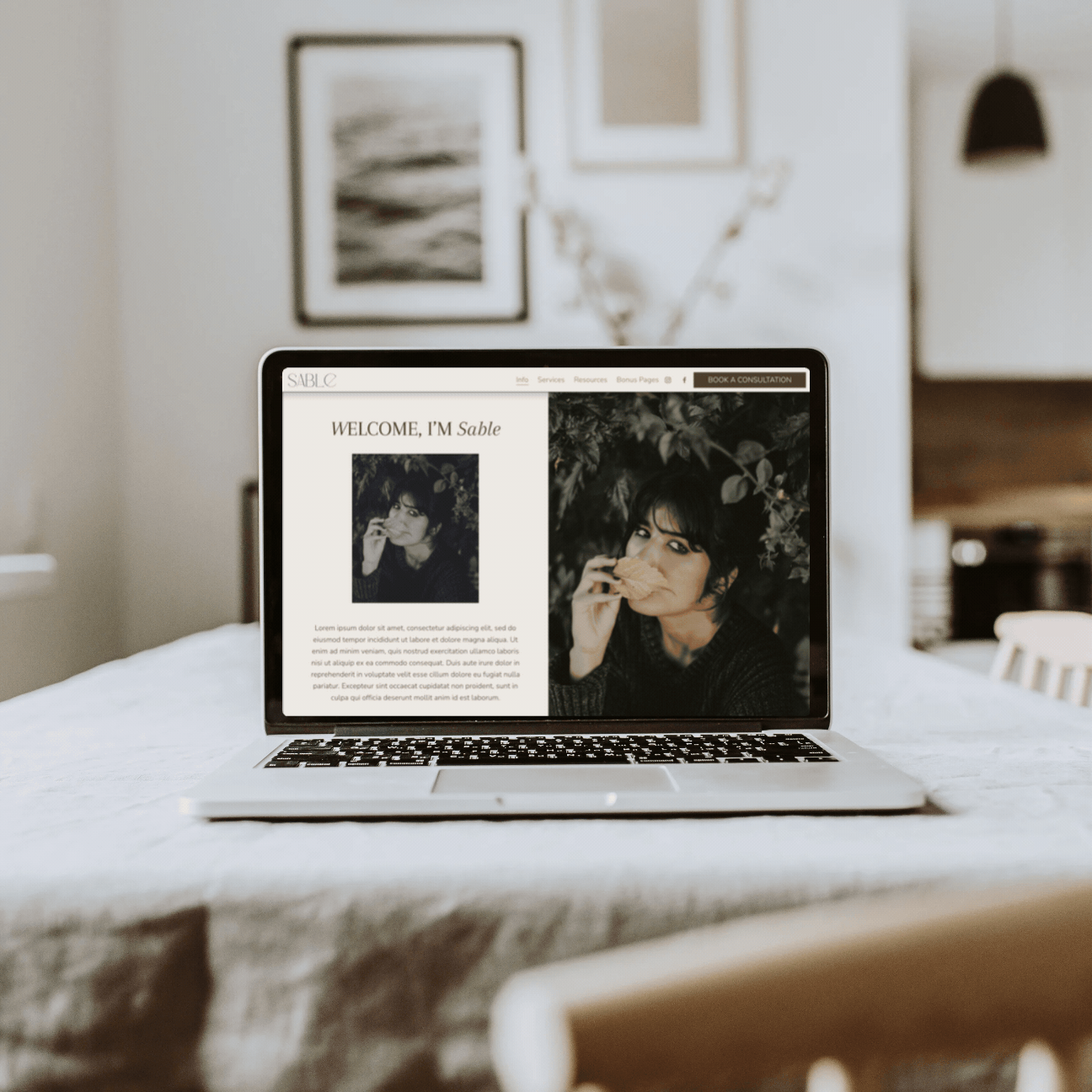 Moving image of Sam Ferguson's launch website templates, De Beauvoir, Sable and Hepburn on a laptop, with soft cream living room backdrop