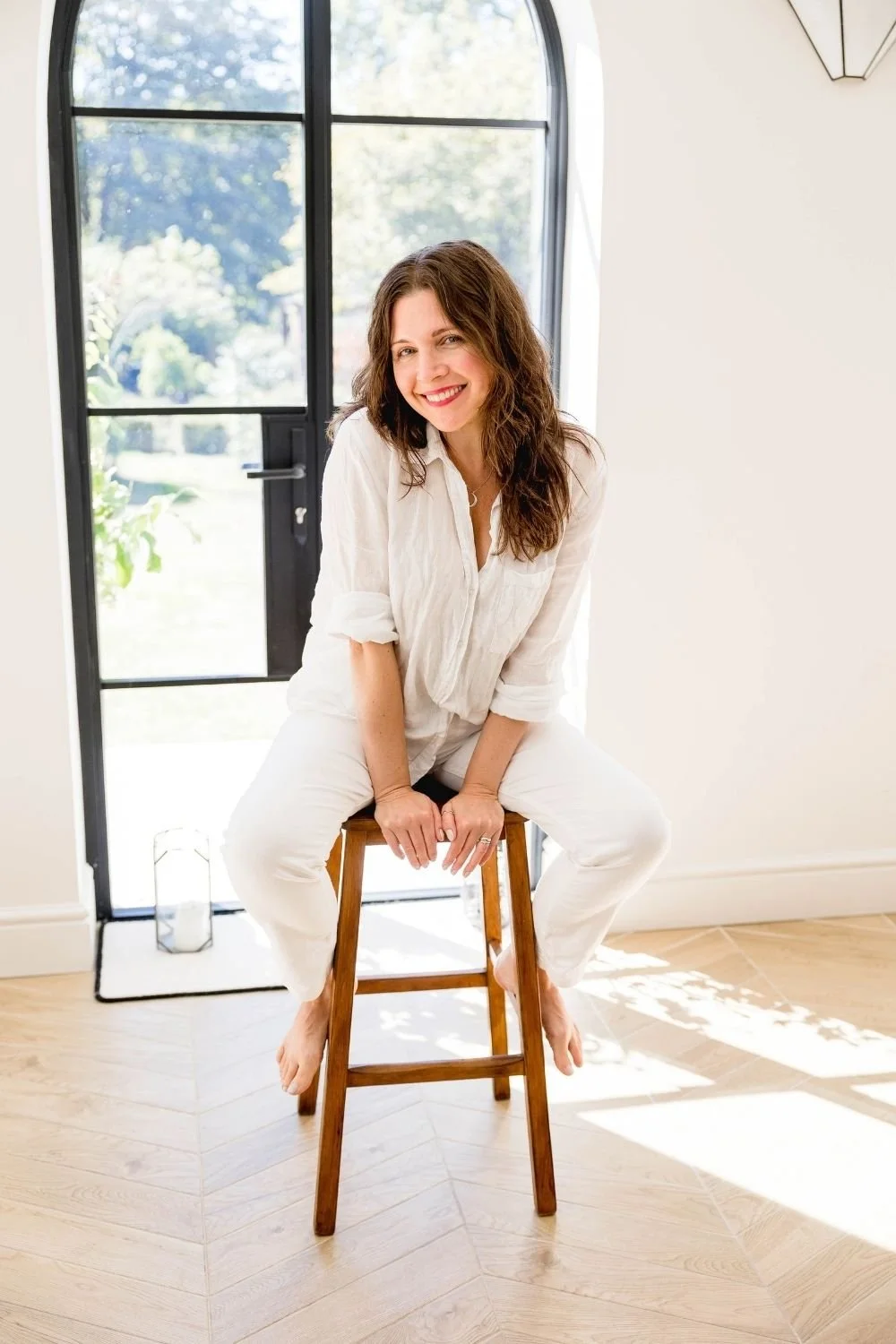 Sam Ferguson sitting on a stool, smiling