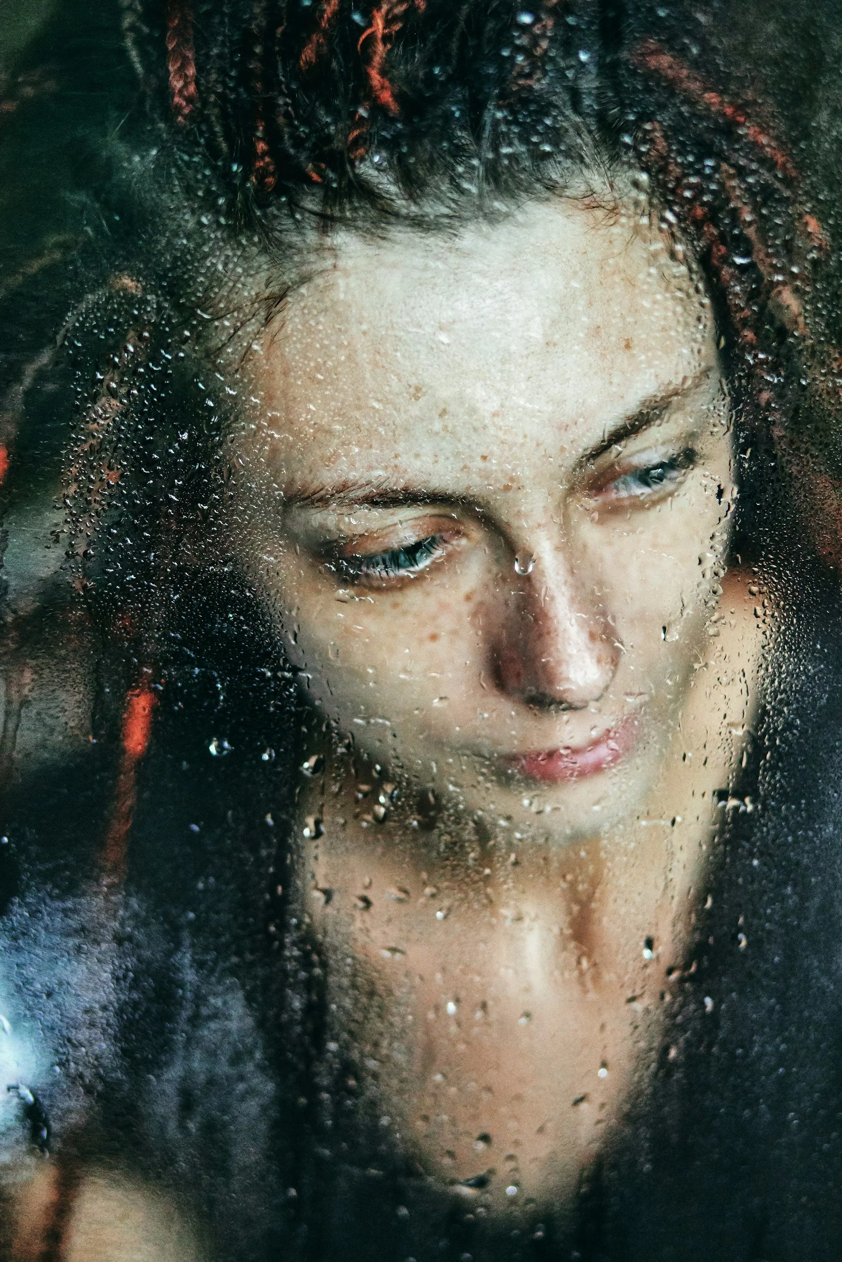 woman behind window covered with condensation