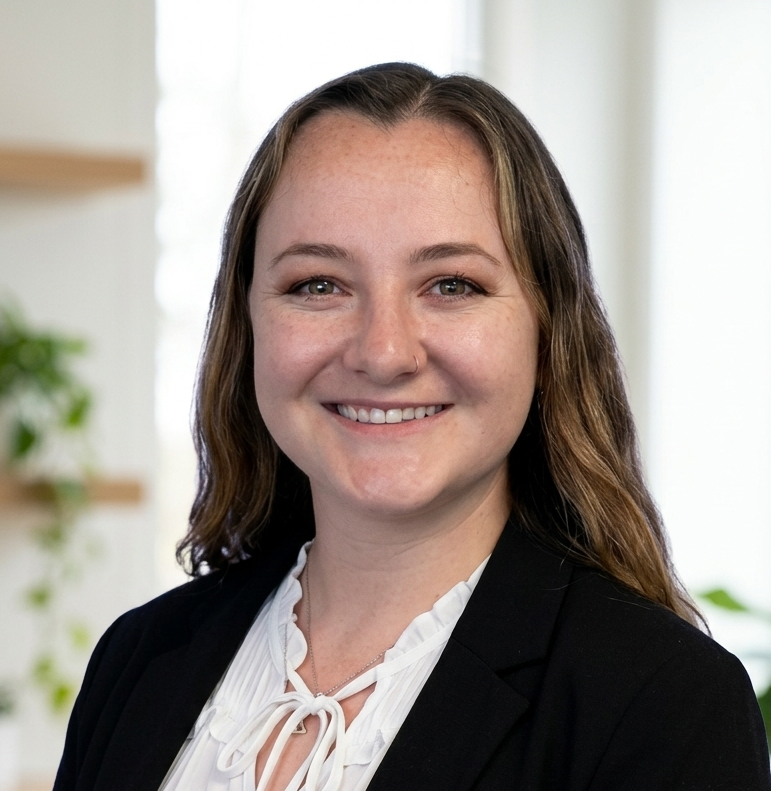 professional headshot of a brunette woman wearing a white shirt and black blazer