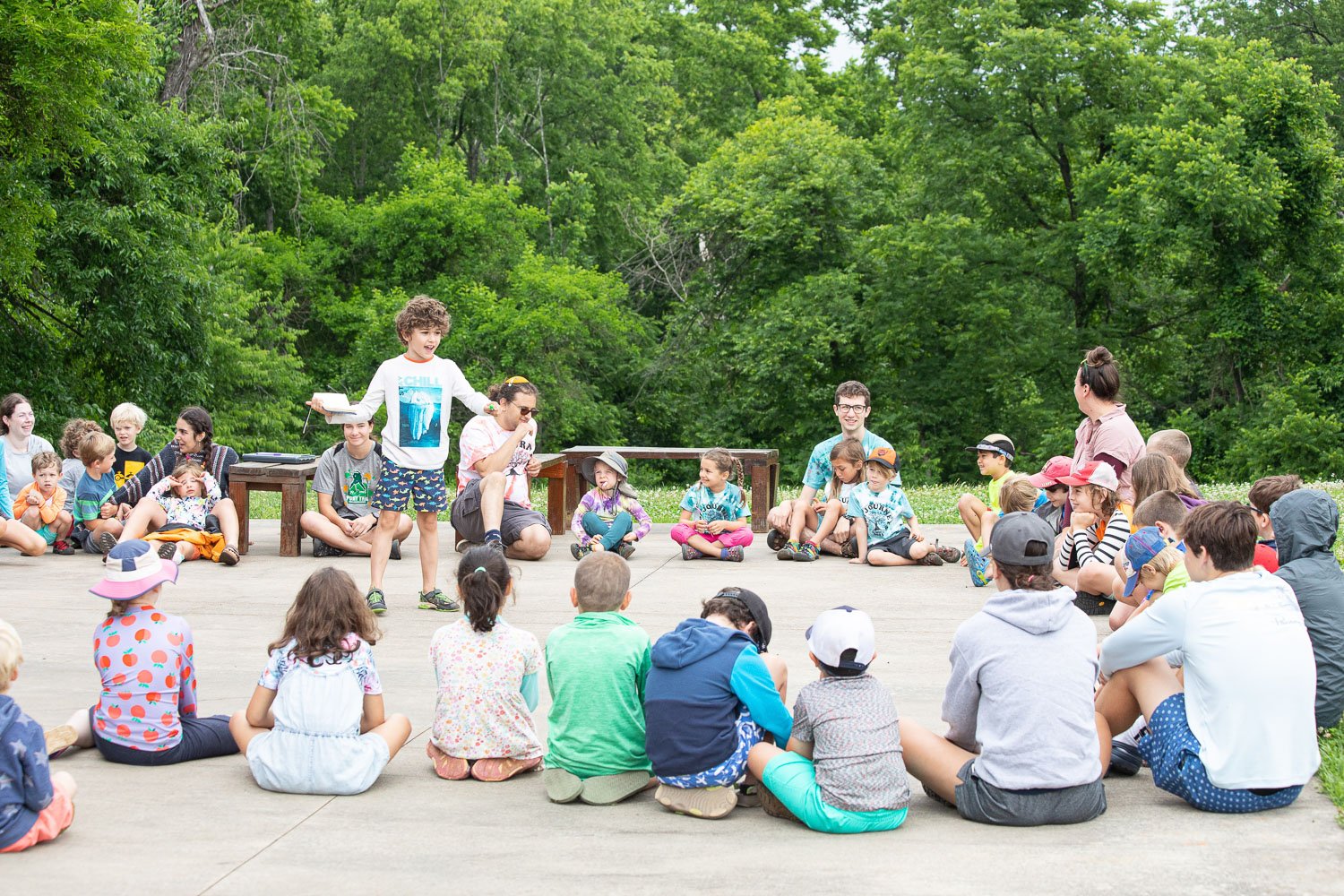 At CBI Camp: Journeys, a summer camp in Charlottesville, Virginia, campers sit in a circle during song time