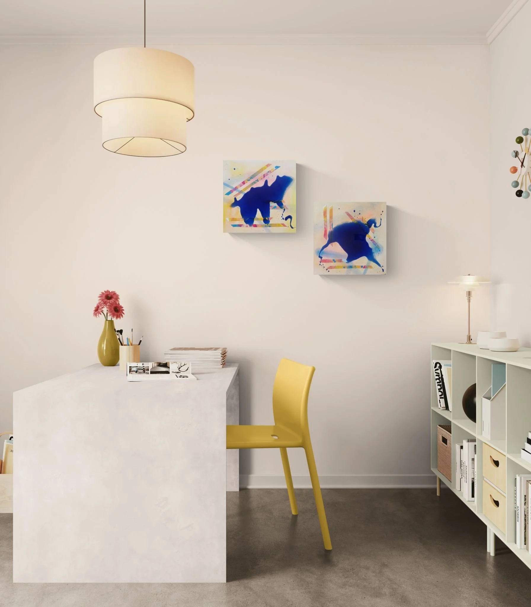 Interior of a room with white walls, a white bookshelf with storage boxes, a yellow chair, a white table with a yellow vase holding pink flowers, and two abstract paintings of blue elephants on the wall. There is a modern white lamp hanging from the ceiling.