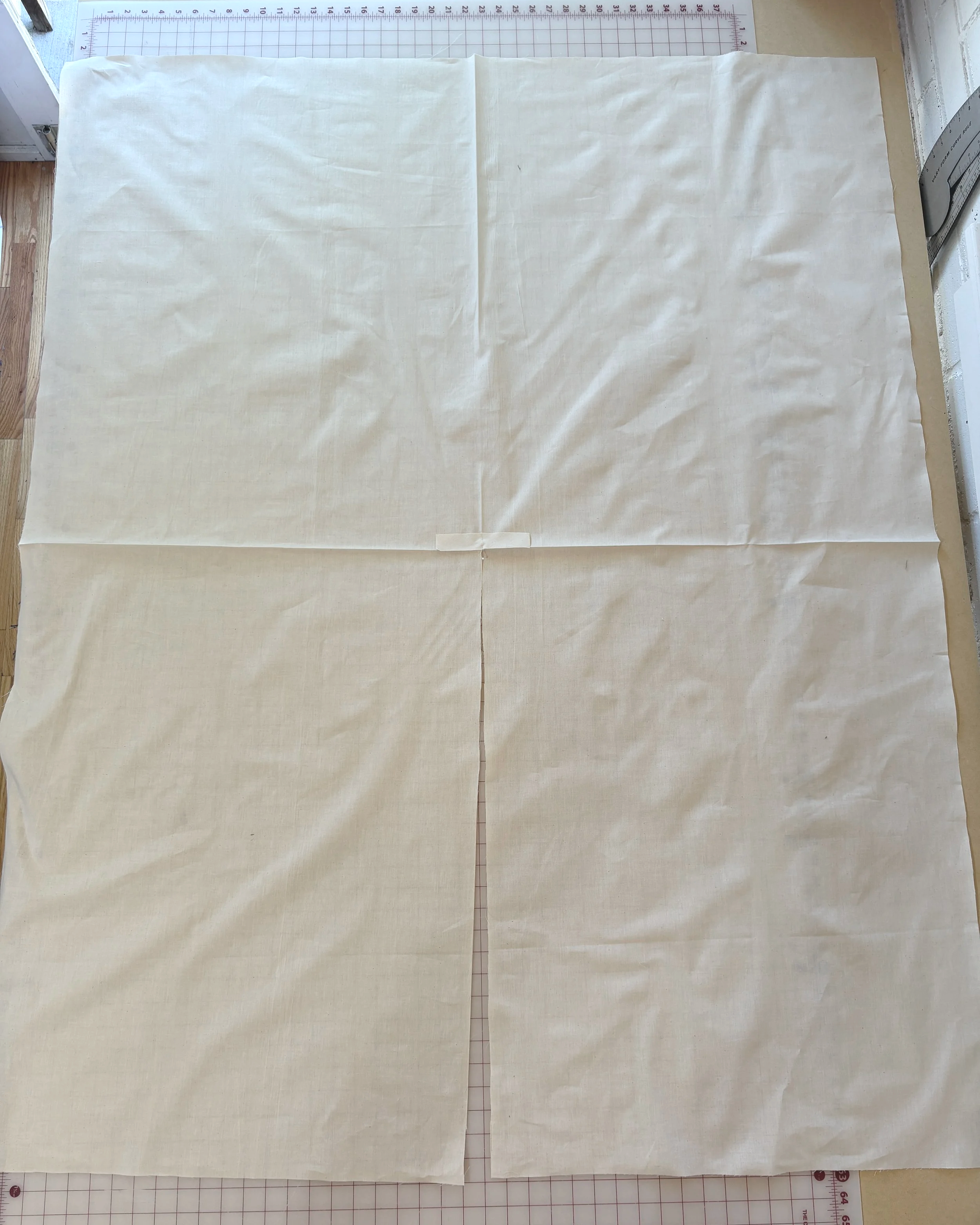 Bias strip pinned right sides together over the slit point at center back neck, raw edges aligned, reinforcing the opening before sewing