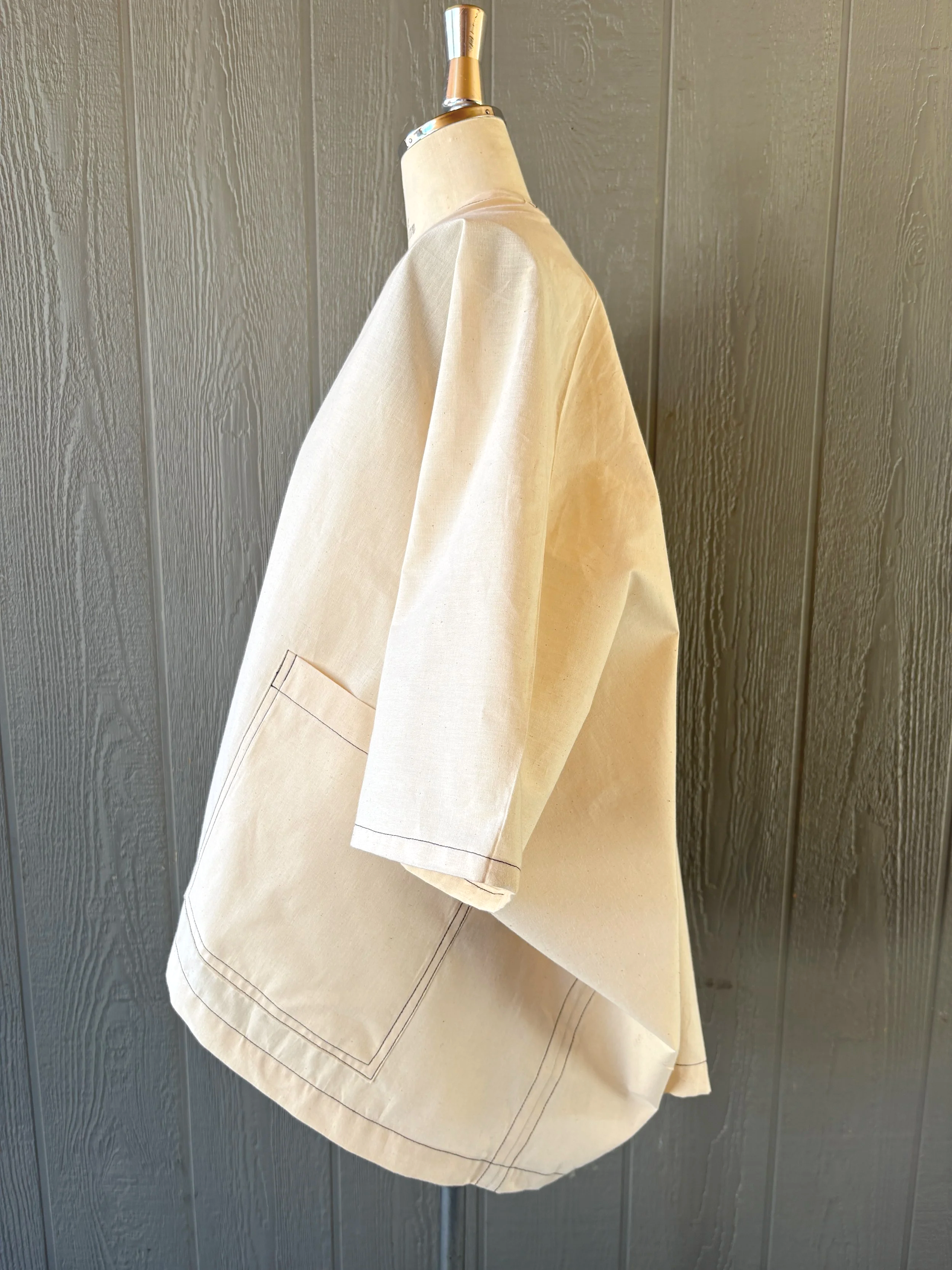 Finished kimono wrap cover-up in muslin, side view, showing the armhole opening and hem length