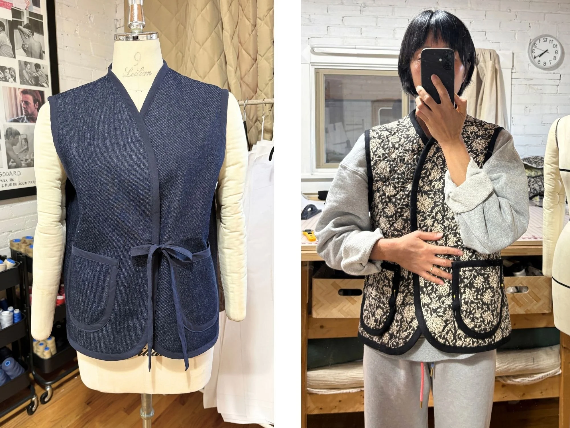 Two Nomad Utility Vest samples: a navy denim vest with navy binding and a tie closure on a dress form, and a black and cream floral quilted vest with black binding, worn over a gray sweatshirt with pins in the pocket