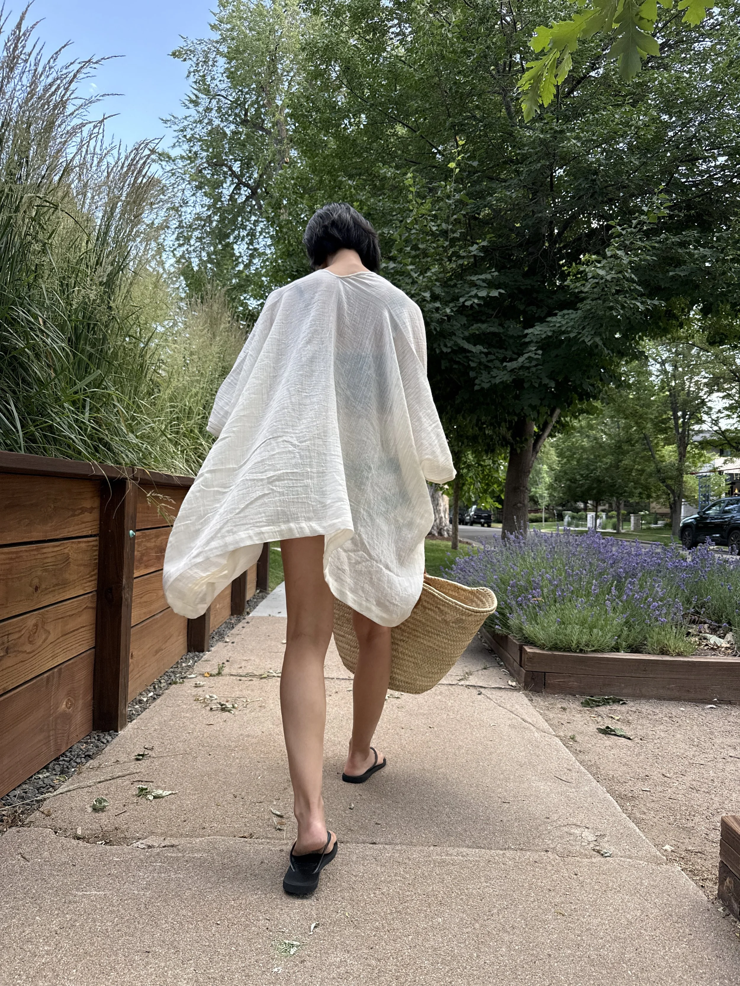 Woman wearing the short kimono cover-up in white cotton gauze, back view