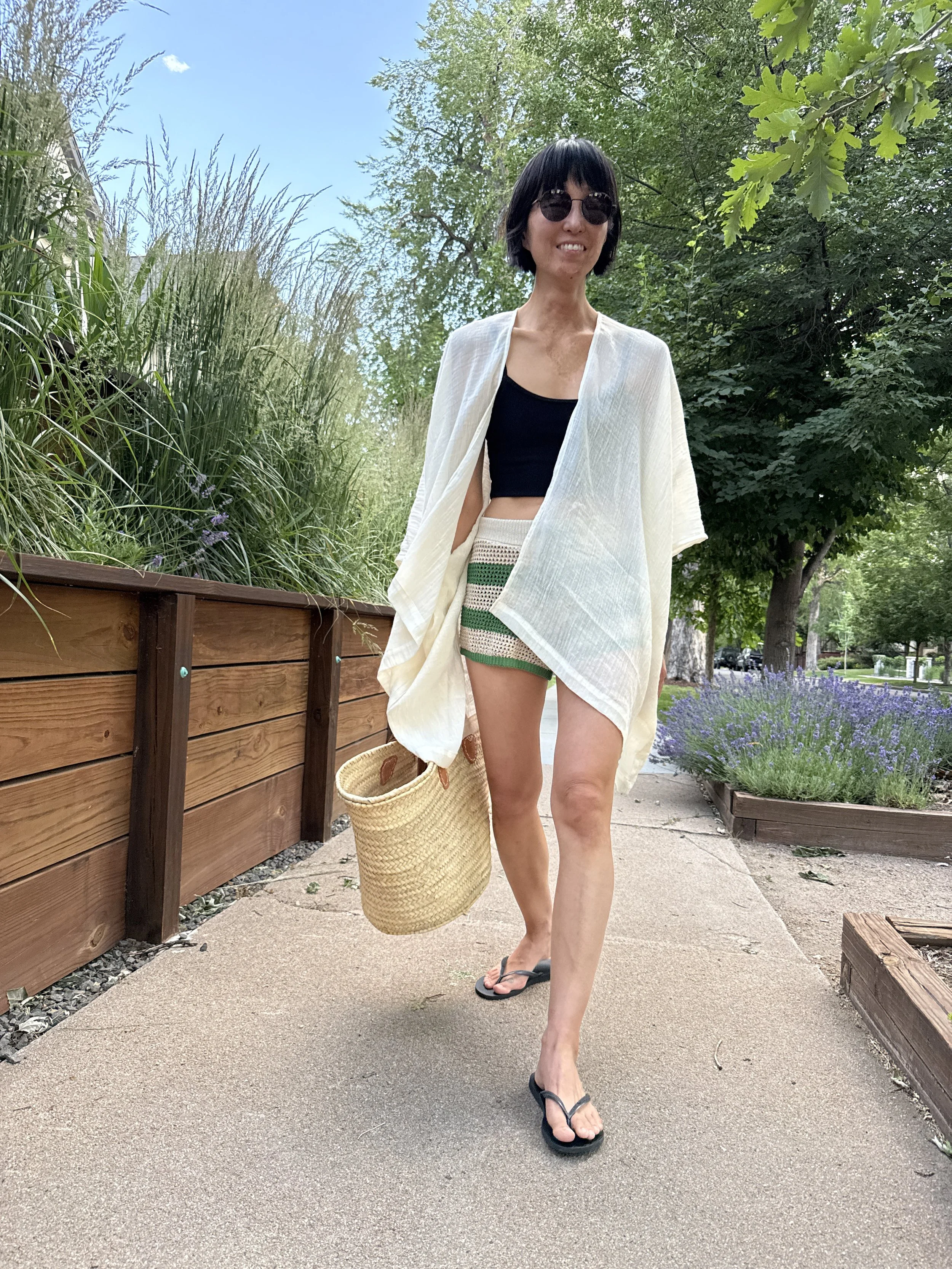 Woman wearing the short kimono cover-up in white cotton gauze, no pockets, front view