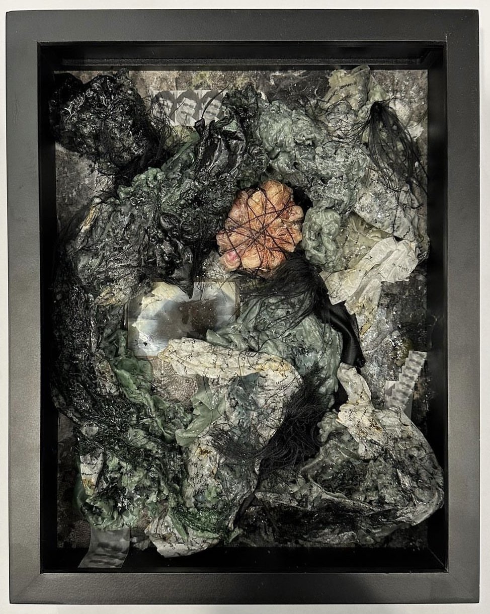 Nazli Efe; My Father’s Mustache 2022
Beeswax, marbled paper, paper, photo, metal wire, plastic netting, fabric, cotton
thread, acrylic, oil pastel.
15 x 12 x 3 in