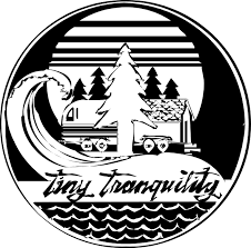A circular logo featuring a pine tree, a wave, a vehicle, and a house with the words 'tiny tranquility'