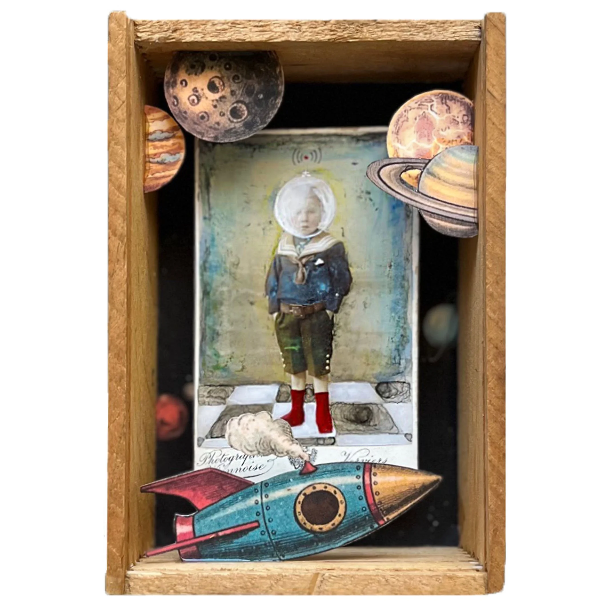 3D collage shadowbox featuring an altered Victorian photo of a boy wearing a fishbowl helmet with planets and a rocket nearby