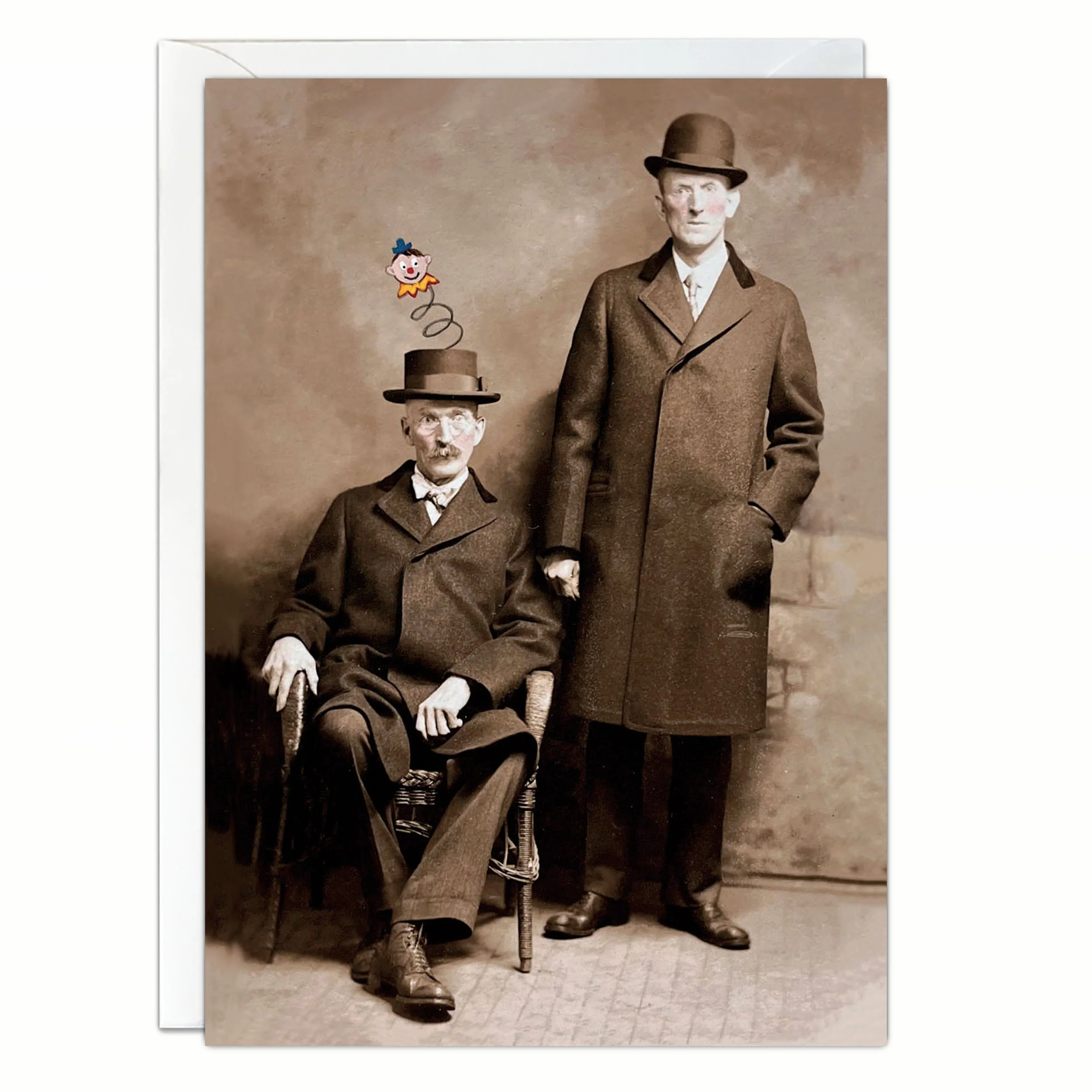 Altered 1910’s photo art print notecard featuring two serious men in suits, a jack in the box popping out of one man’s hat