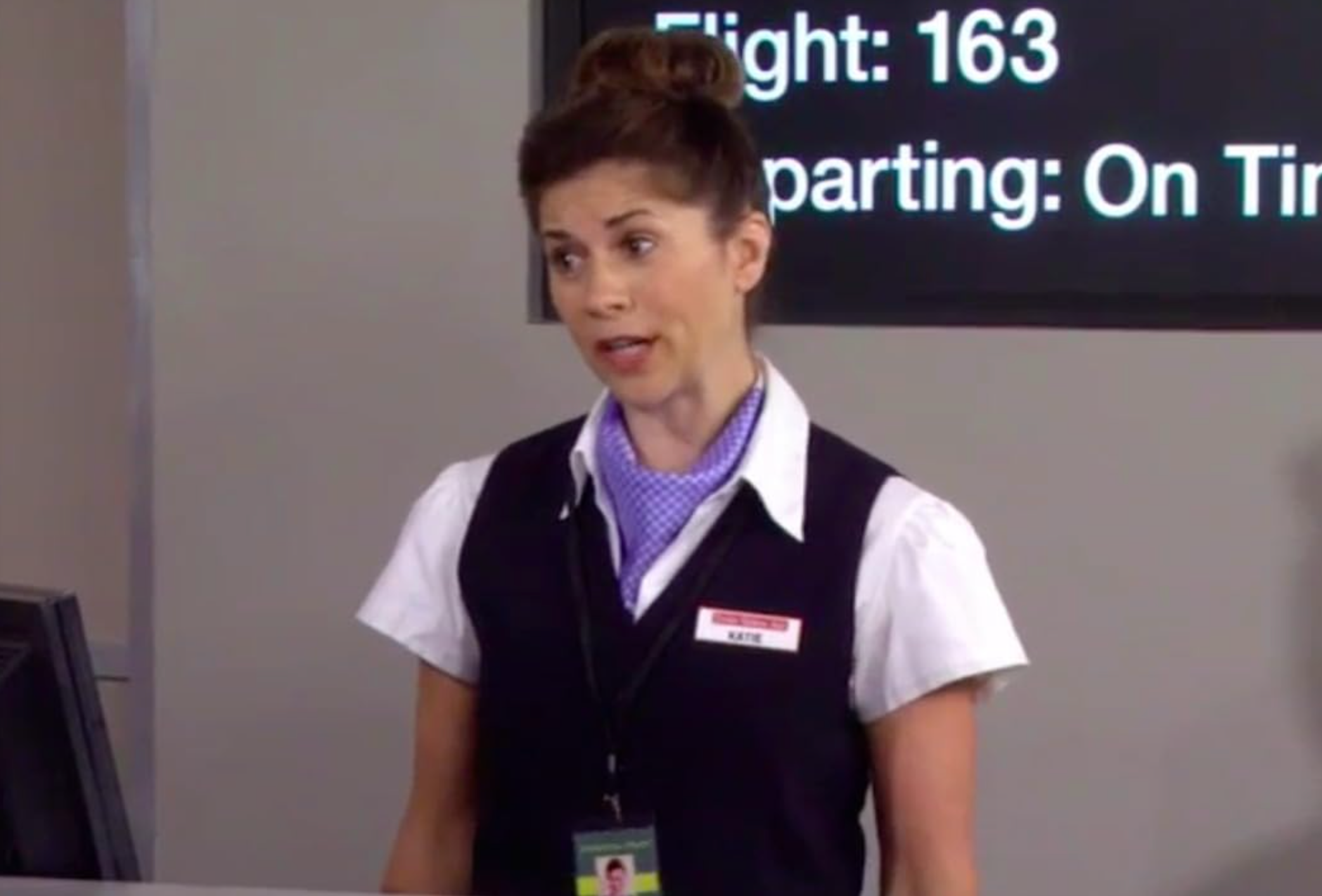 Mary Gallagher in an Airline Agent outfit looking perplexed