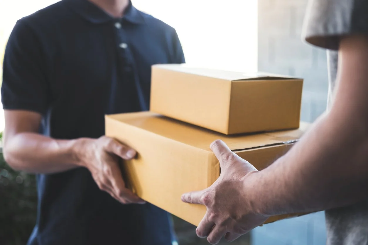 A multi drop courier service delivery a parcel to a man