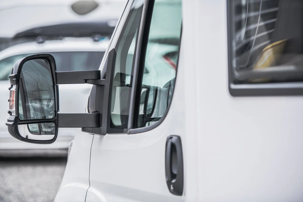 Close up of a multi drop courier van wing mirror