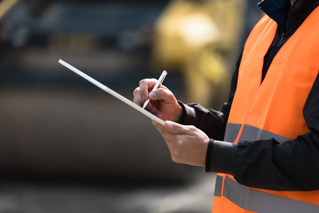 Person writing on a clipboard during handball delivery for large pallet delivery Scotland