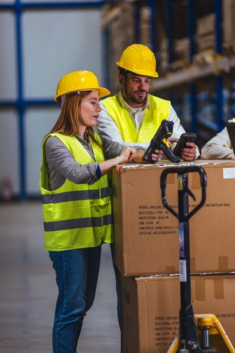 Male and female time critical on board couriers standing in a warehouse
