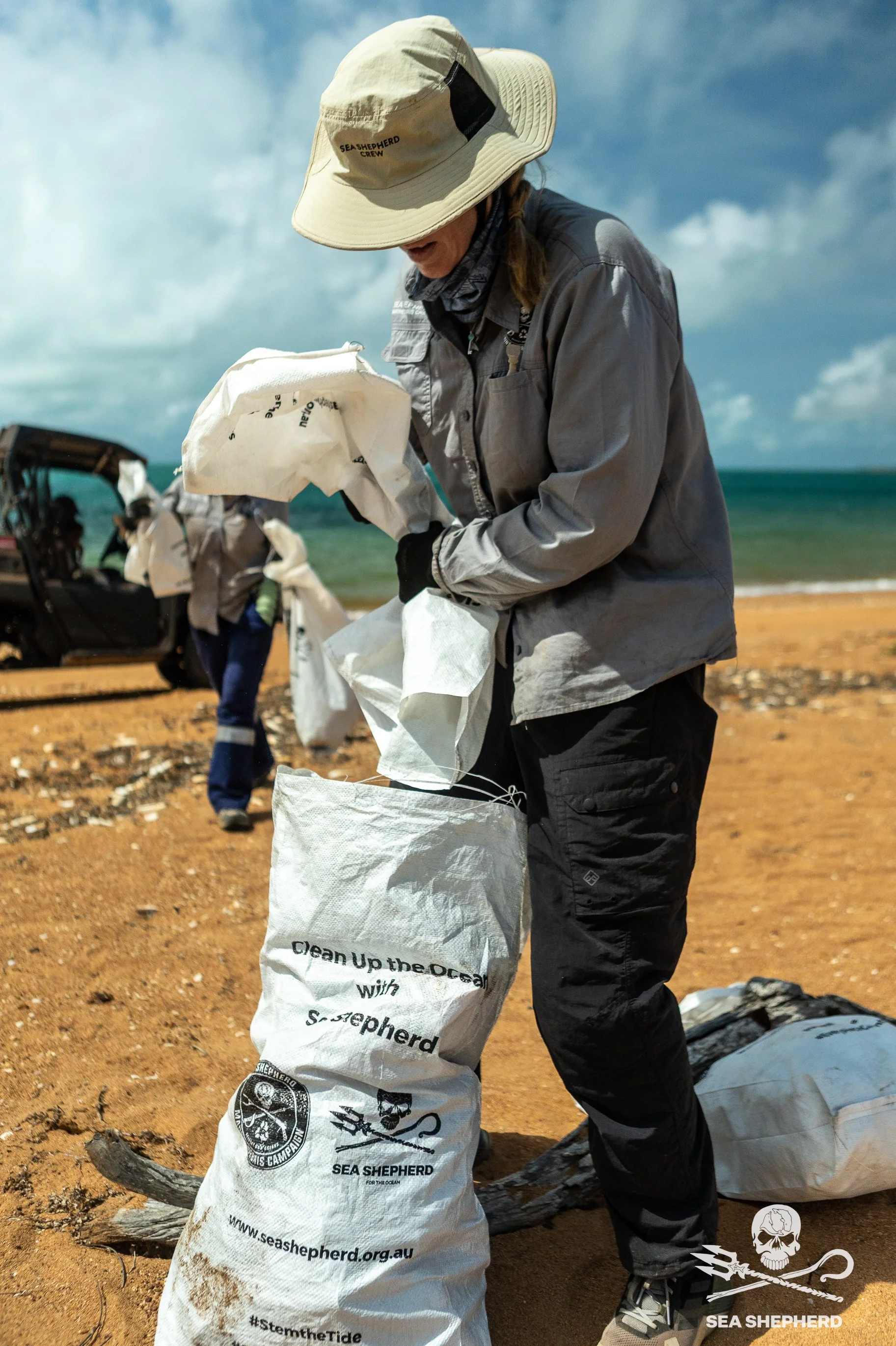 250911_MDC_HB_crew cleaning trash pile_IMG_5672.jpg