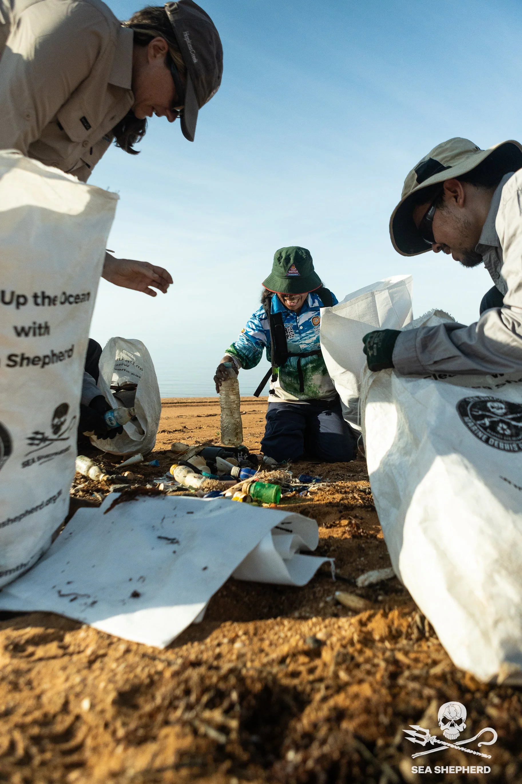 250911_MDC_HB_crew cleaning trash pile_IMG_5318.jpg