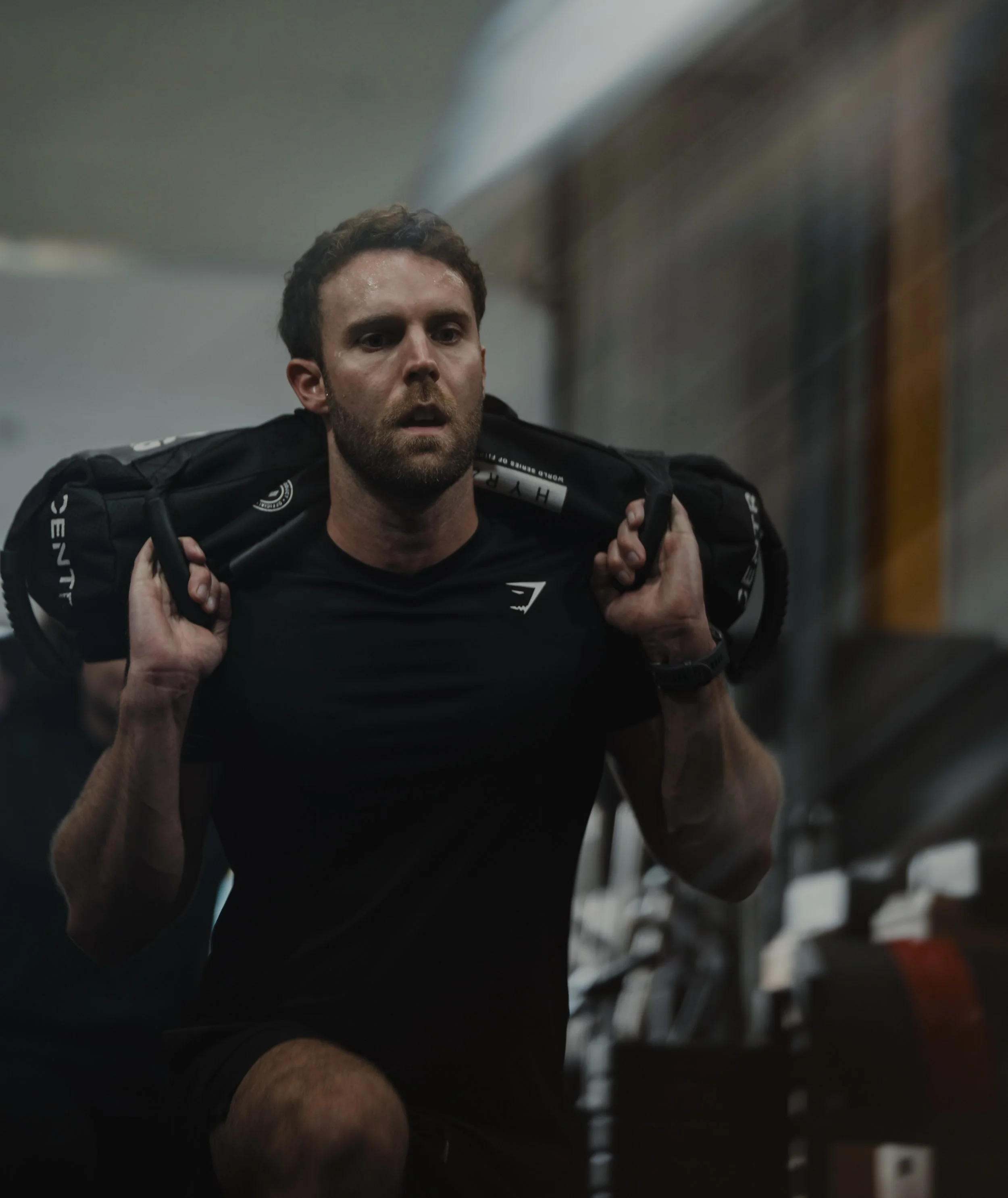 A woman uses a rowing machine during a MetCon class