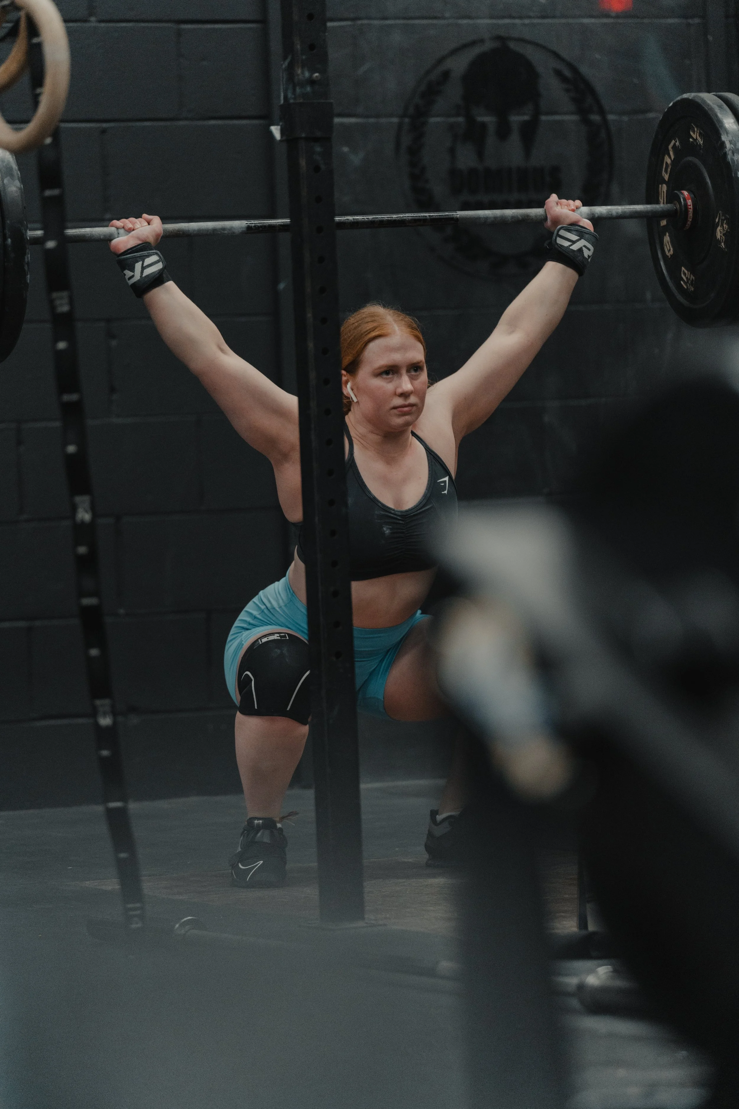 A man using high rings at a competition prep class