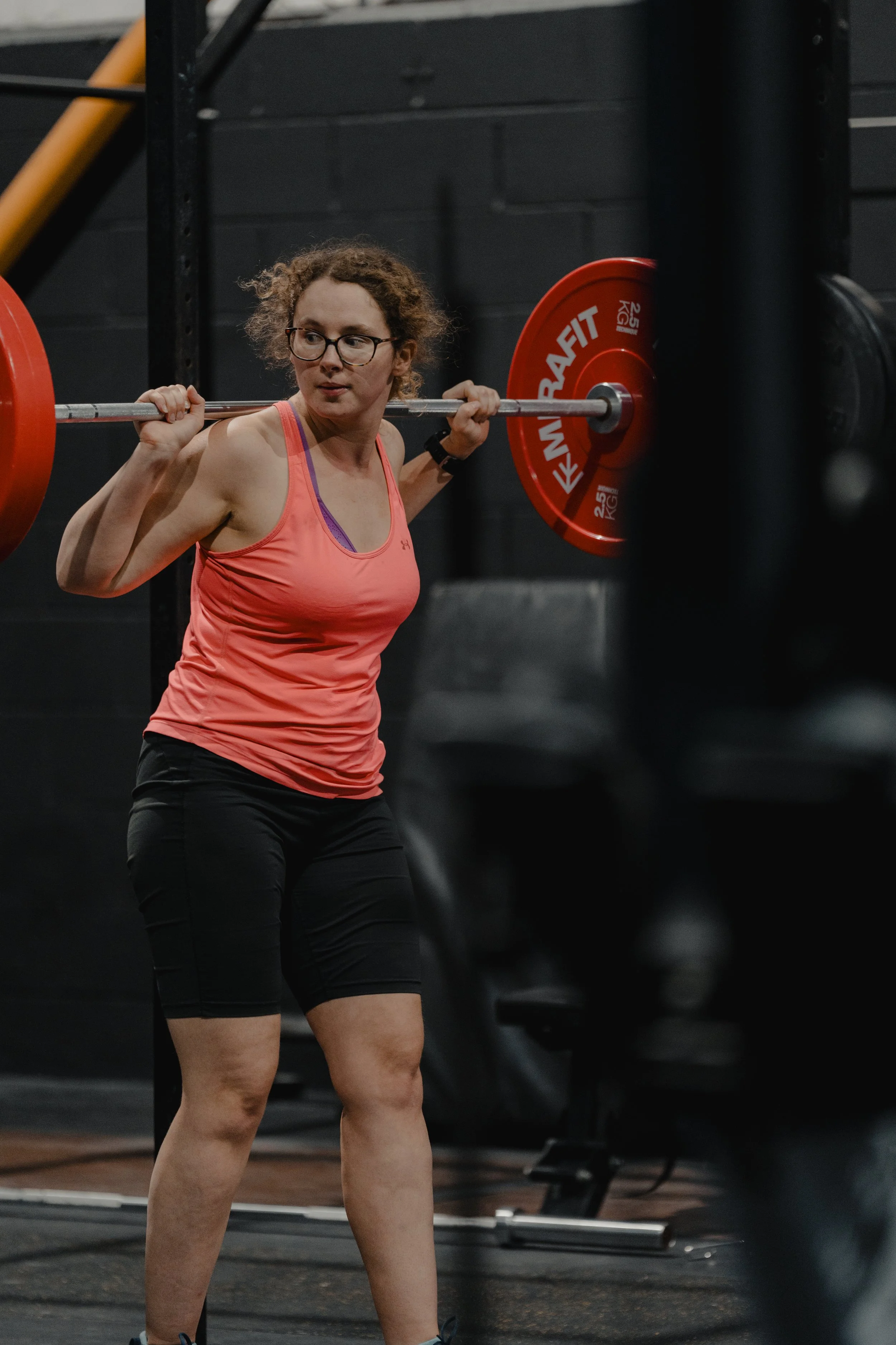 A man using heavy hand weights during an open gym session