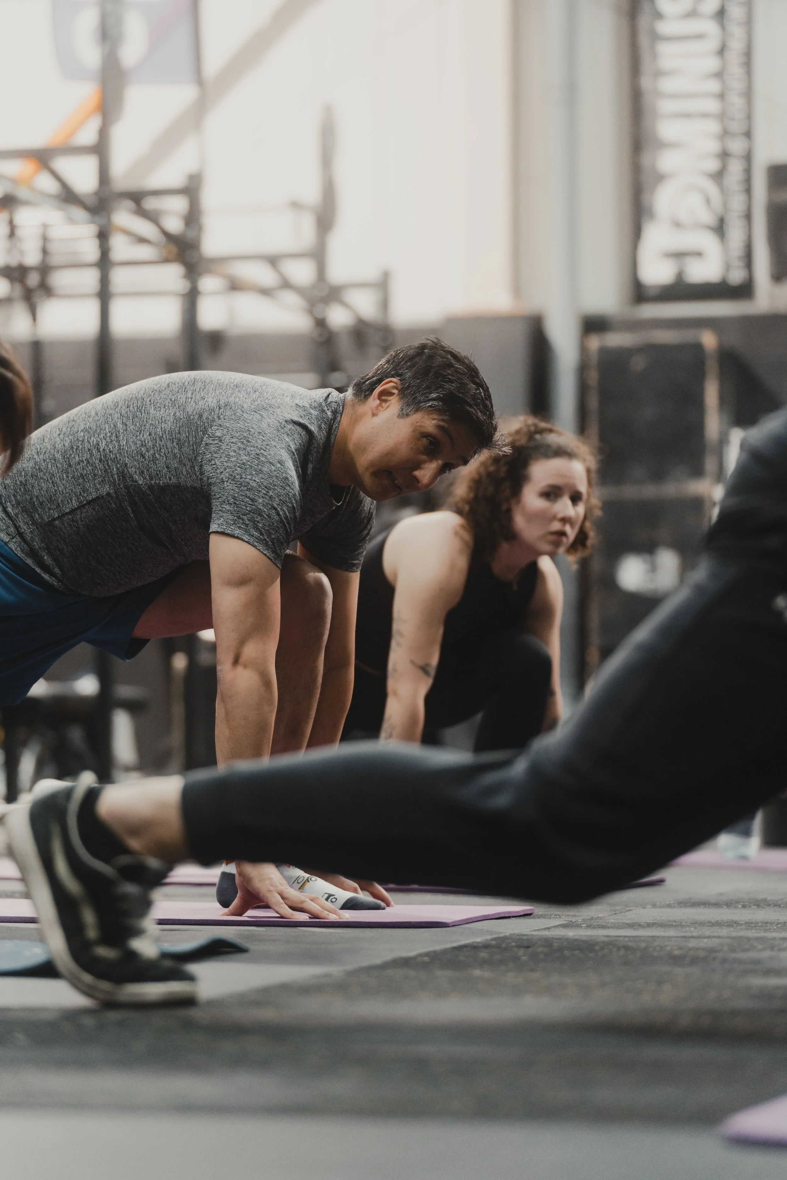 A woman performing a pose during a Yoga class
