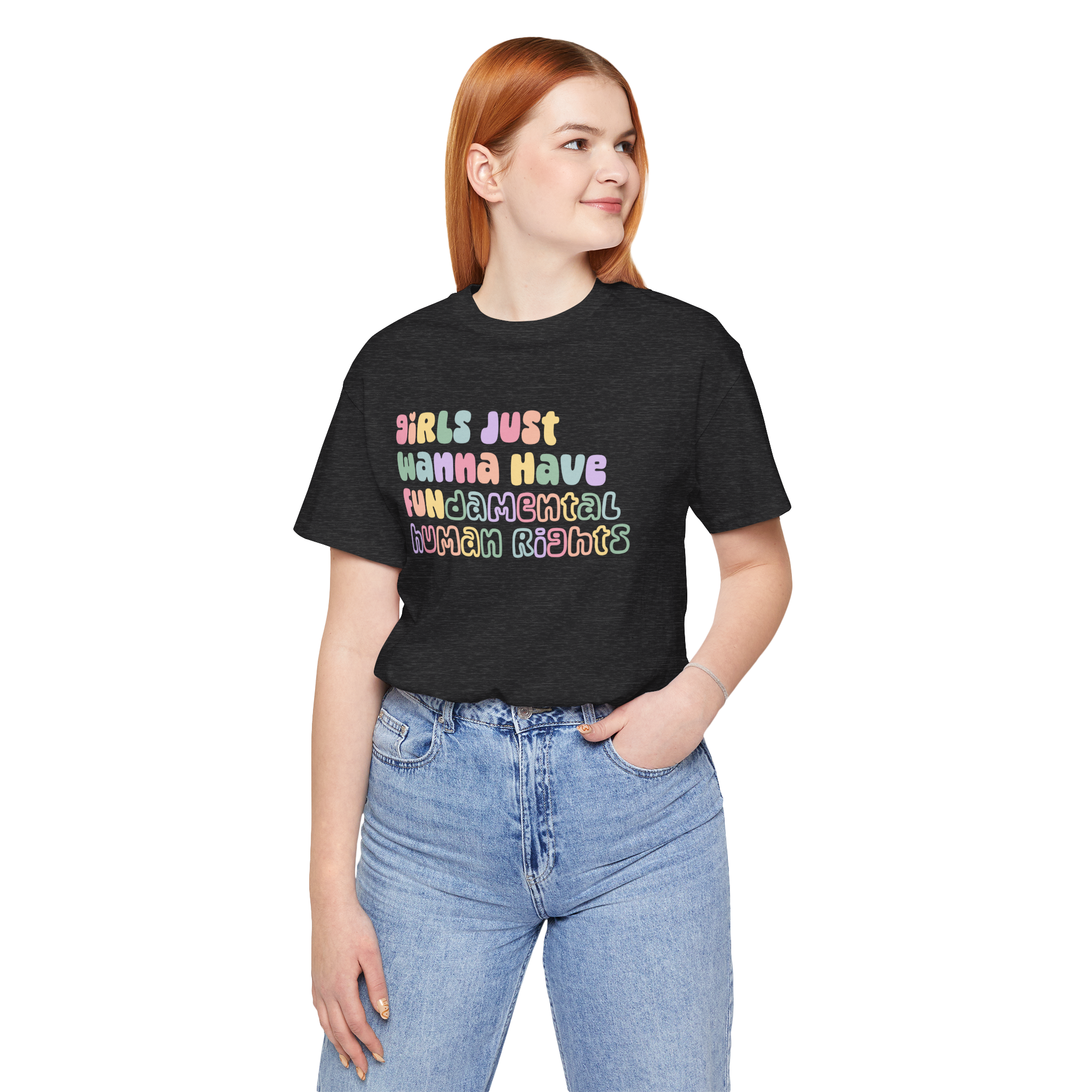 A woman wearing a dark gray t-shirt with the phrase "Girls Just Wanna Have Fundamental Human Rights" in pastel rainbow letters across the front.