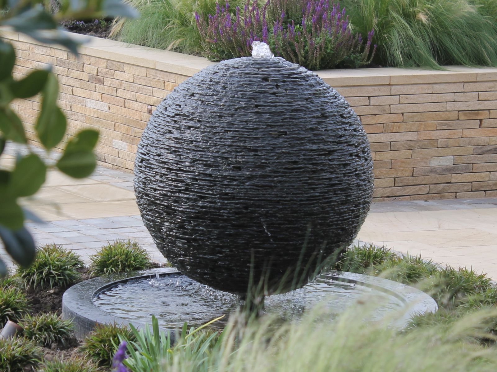 Sphere (Water Feature) in Stacked Slate
 
The essence of simplicity. The uncomplicated, yet uniquely satisfying form is timeless. The addition of water brings another dimension; the gentle and calming murmur of flowing water.

Water sculptures are pr