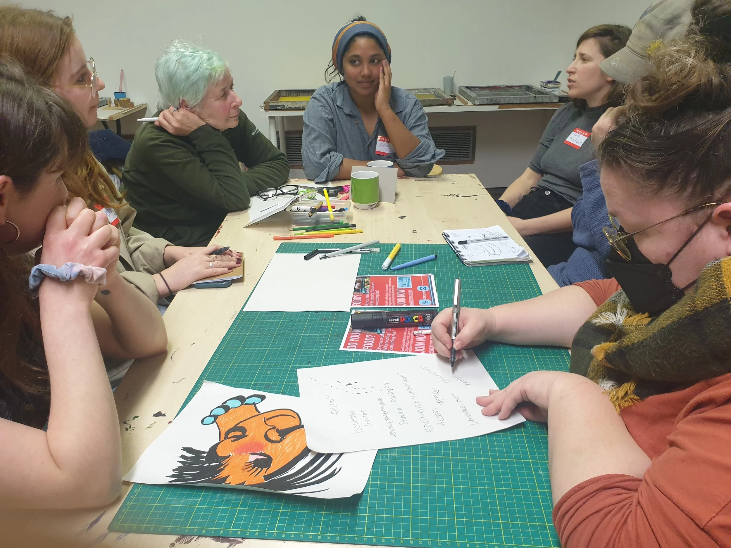 Community housing workshop with renters and kids making protest art, hosted by Food & Solidarity in Newcastle.