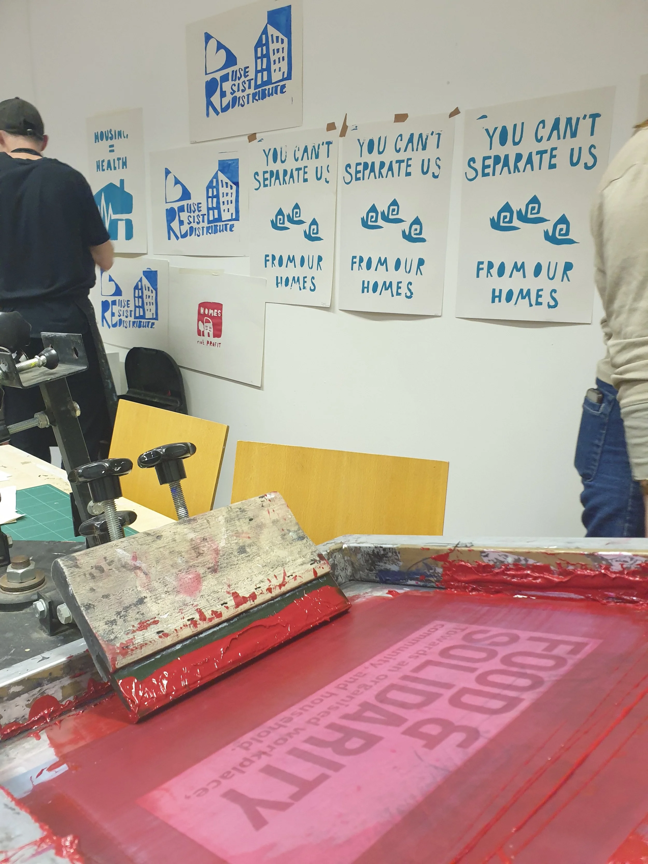 Screen-printing protest posters at Food & Solidarity housing workshop—art as a tool for tenant organising and eviction resistance.