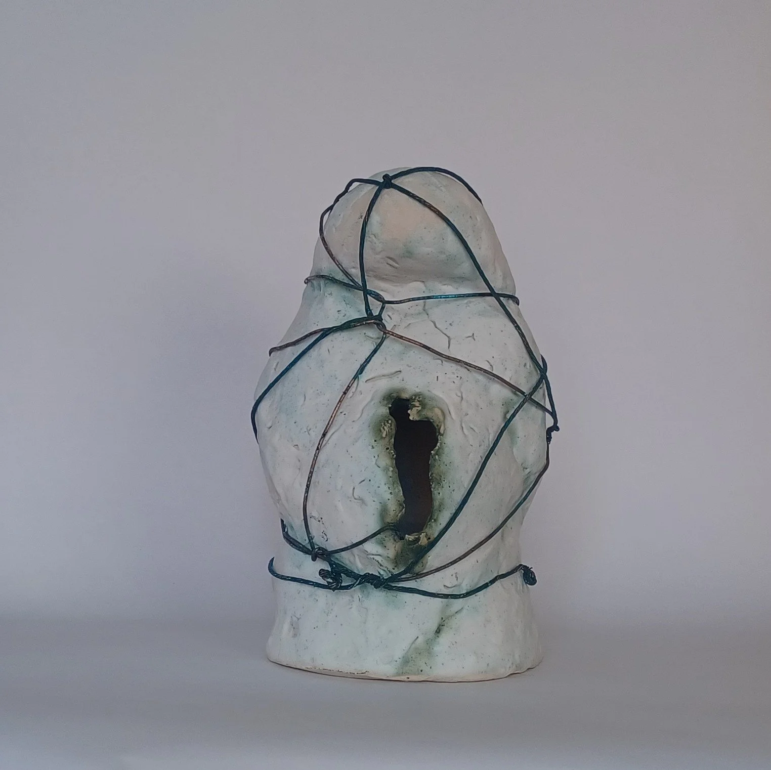 2026. Captive 2. Porcelain with glaze and copper wire. 11.25 x 7.25 x 8 .25 Inch. (28.57 x 18.41 x 21 cm)