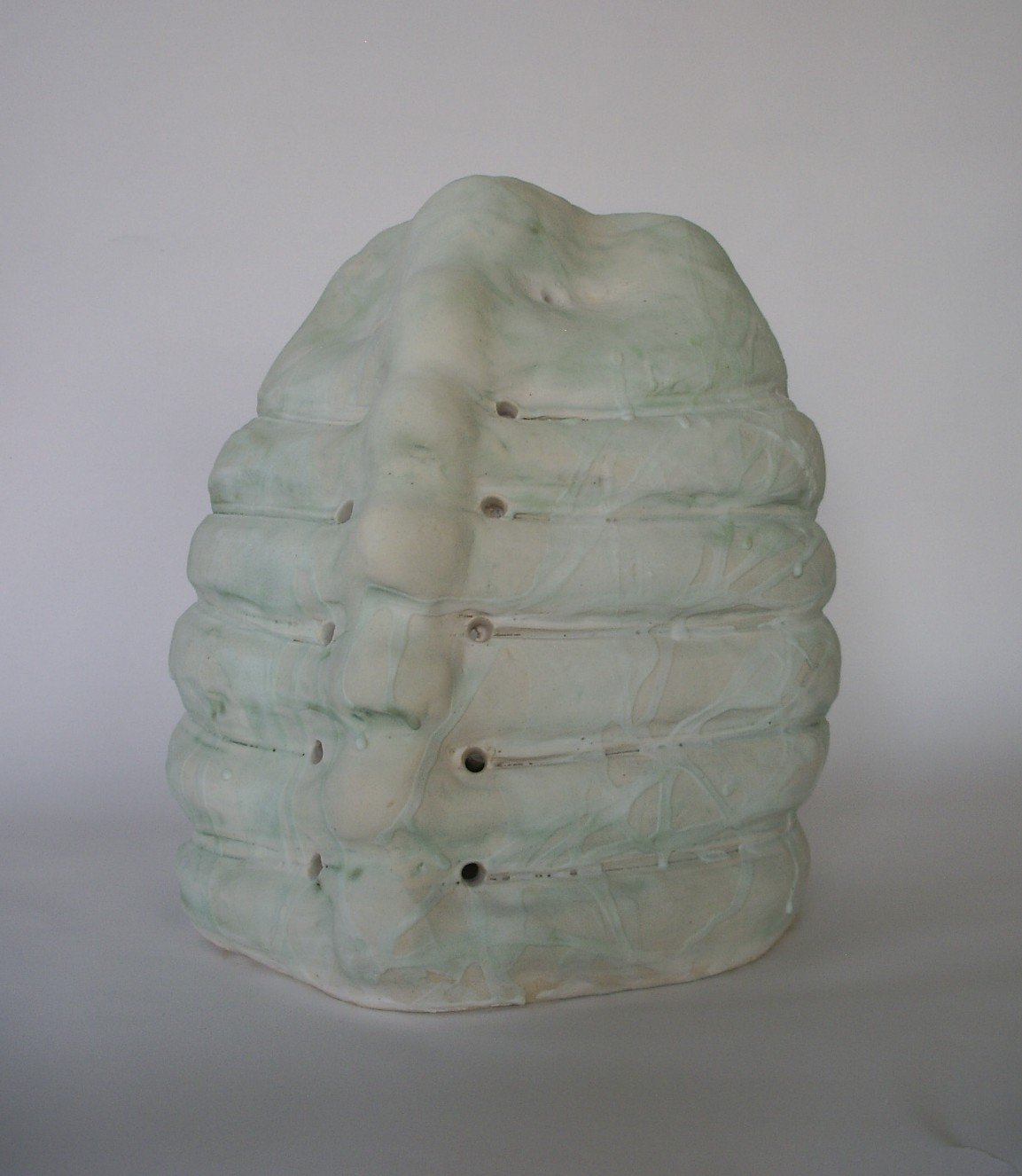 2025 Famine 2, third view. Porcelain with glaze. 10 x 9 x 8.25 inch (25.4 x 22.86 x 21 cm)
