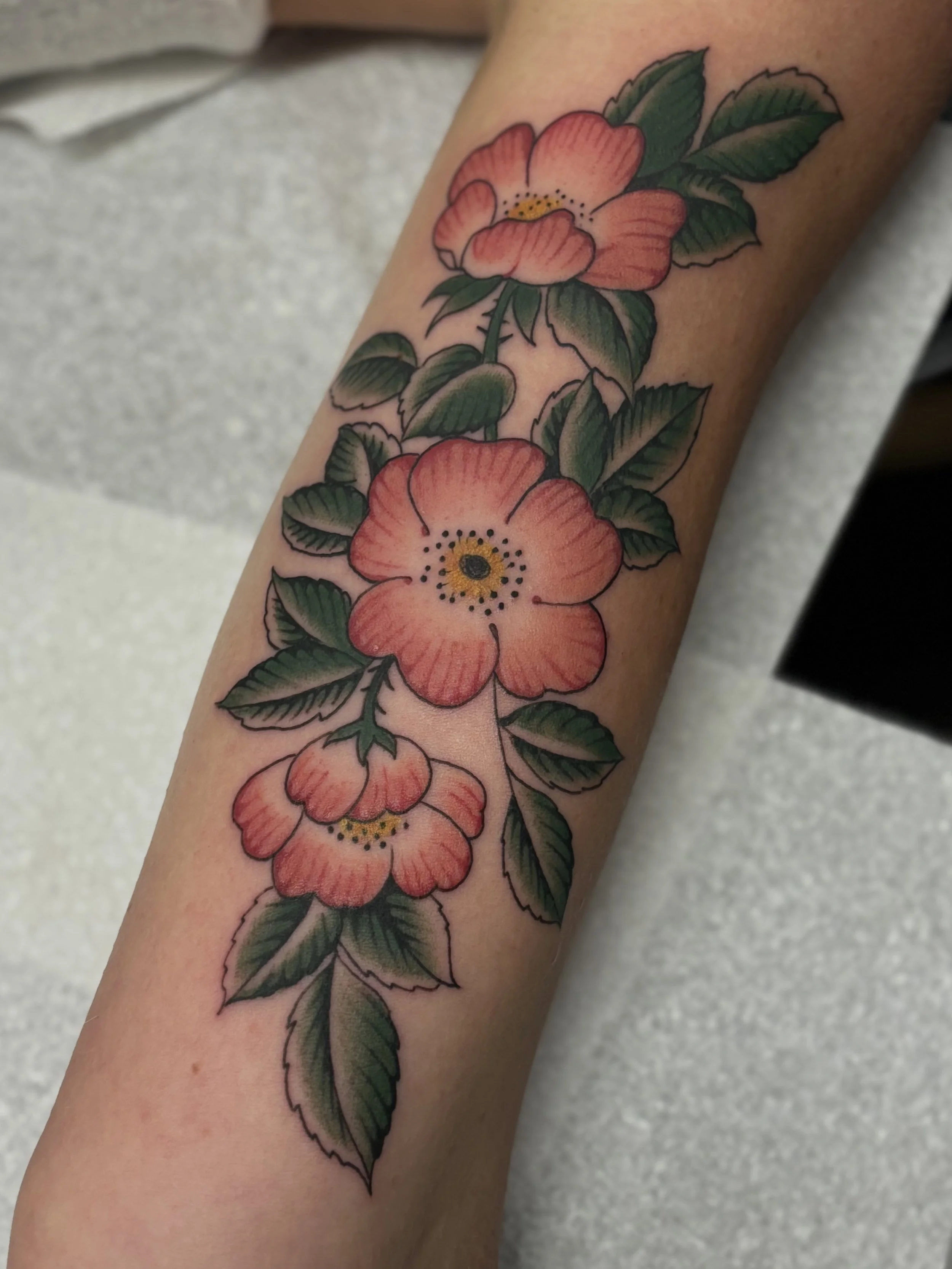 Pink and red cherry blossoms tattooed by Liam Harbison