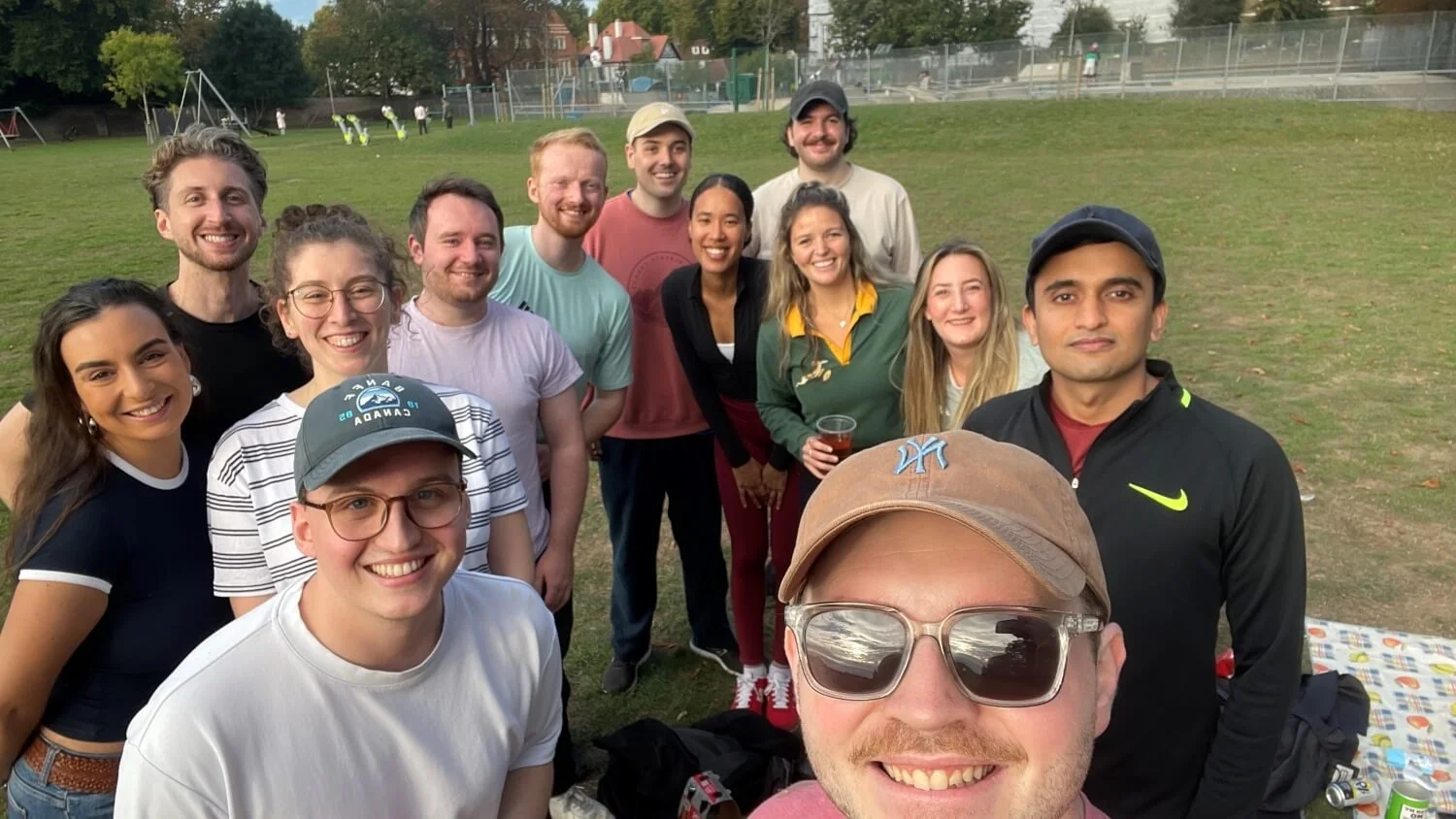 A group of Freya's new friends having a picnic and playing rounders in summer